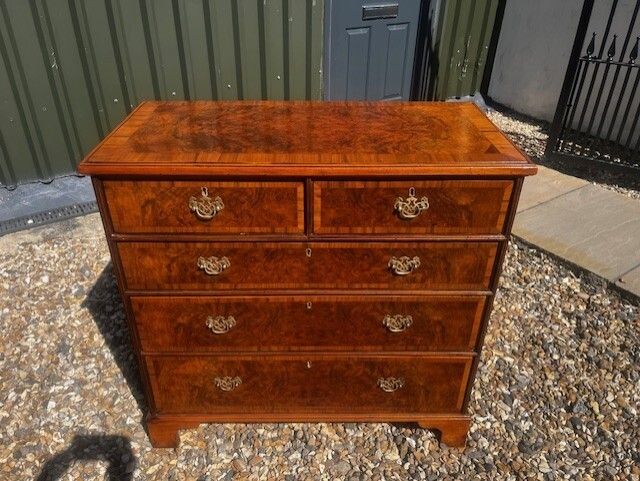 A George II Style Burr Walnut Chest Of Drawers. photo furniture