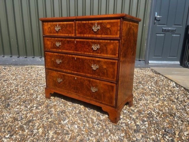 A George II Style Burr Walnut Chest Of Drawers.