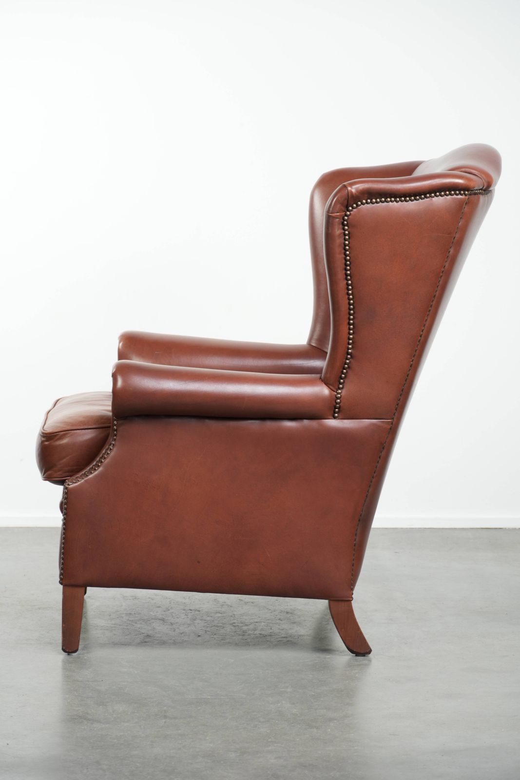 Comfortable Cognac Colored Cowhide Leather Wing Armchair In English Style With A Warm Appearance photo 888.0