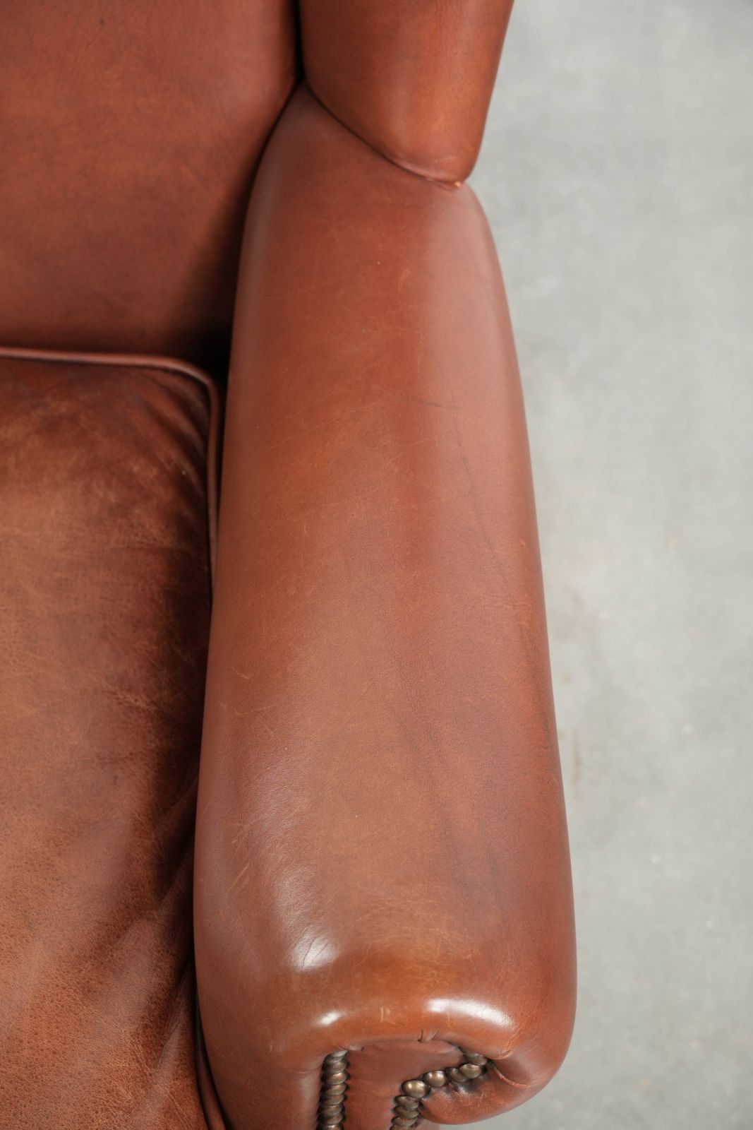 Comfortable Cognac Colored Cowhide Leather Wing Armchair In English Style With A Warm Appearance photo vintage