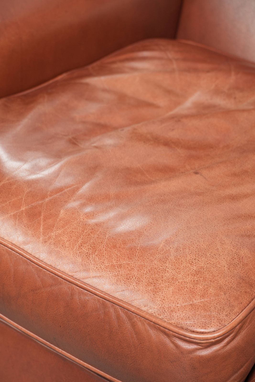 Furniture Comfortable Cognac Colored Cowhide Leather Wing Armchair In English Style With A Warm Appearance photo
