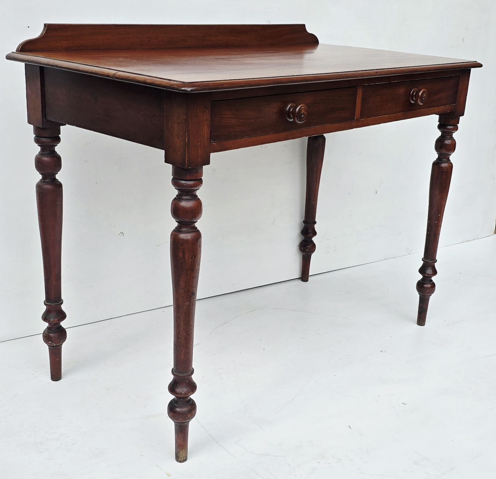 photo furniture An Antique Mahogany Writing Desk On Turned Legs, 19th C.