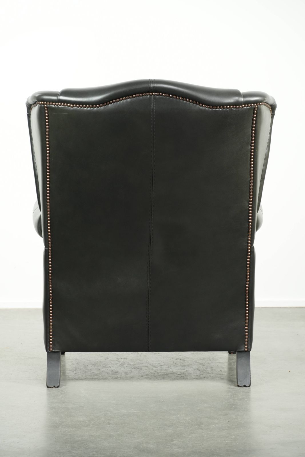 Black Cowhide Wing Armchair In A Classic English Style, Finished With Decorative Nails. photo Furniture