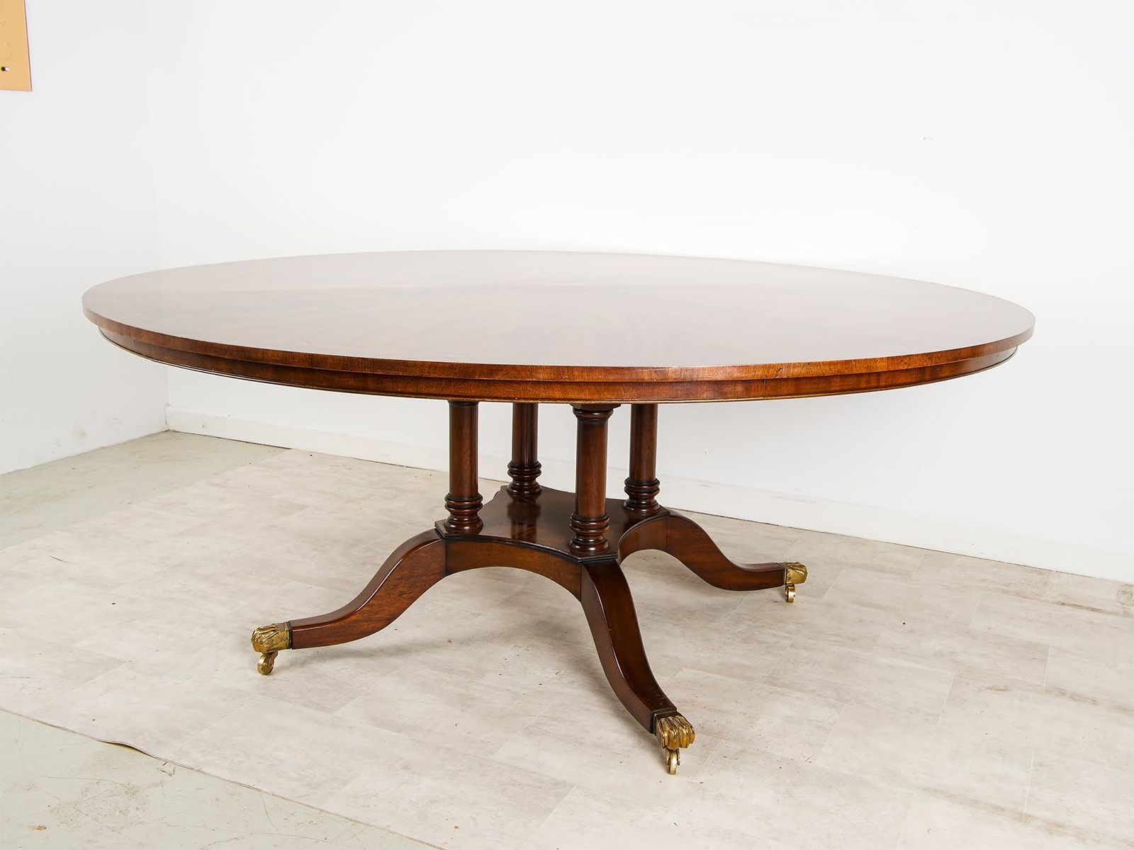 Large Regency Style Flame Mahogany Circular Dining Table With Brass Lion Paw Castors photo furniture