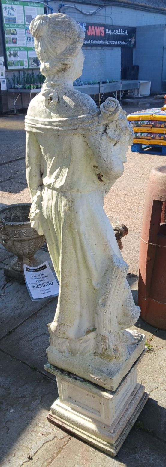 Weathered Concrete Statue Of Female Carrying Flowers photo furniture