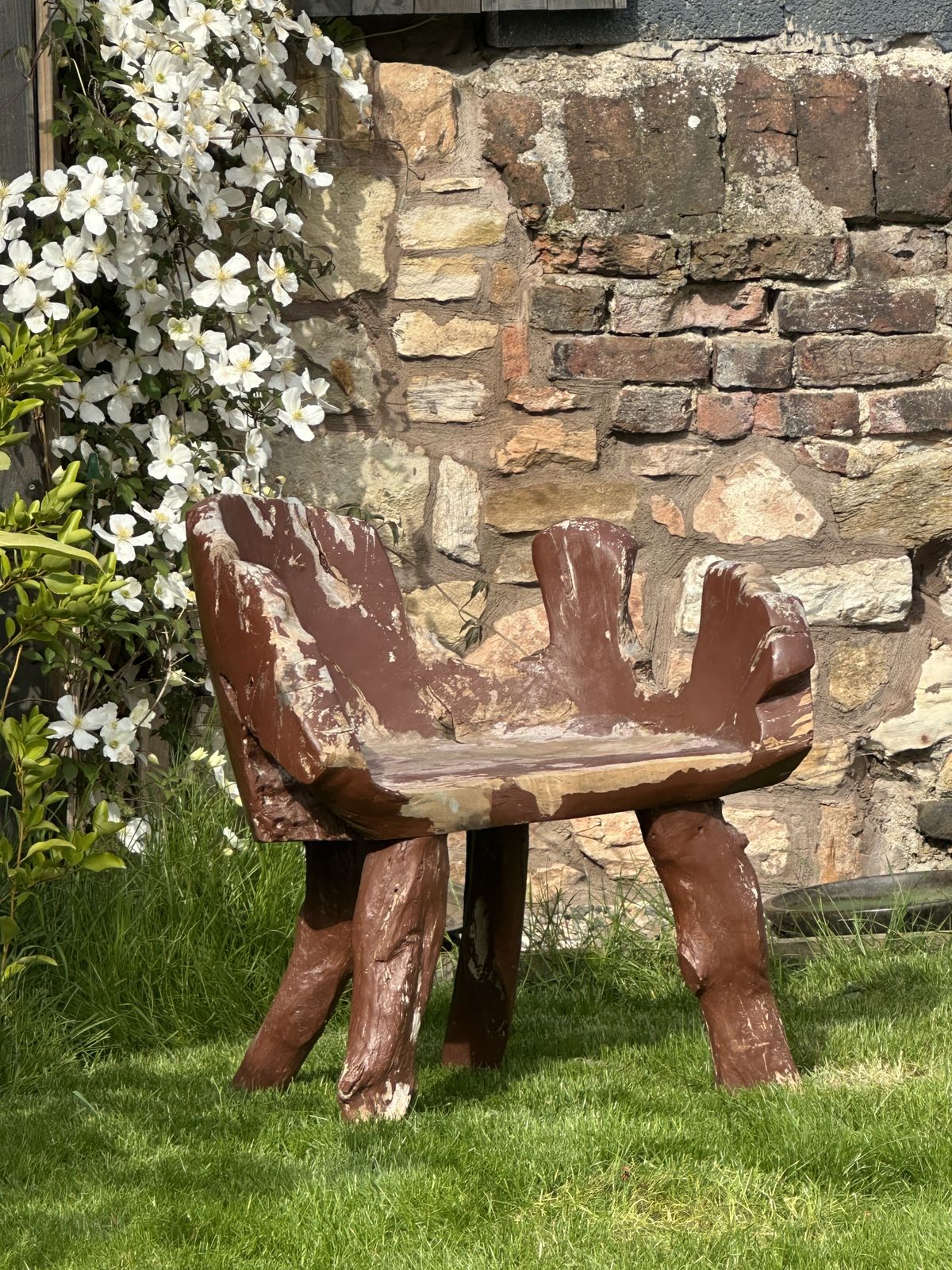 A Root Garden Seat With Weathered Paint Finish