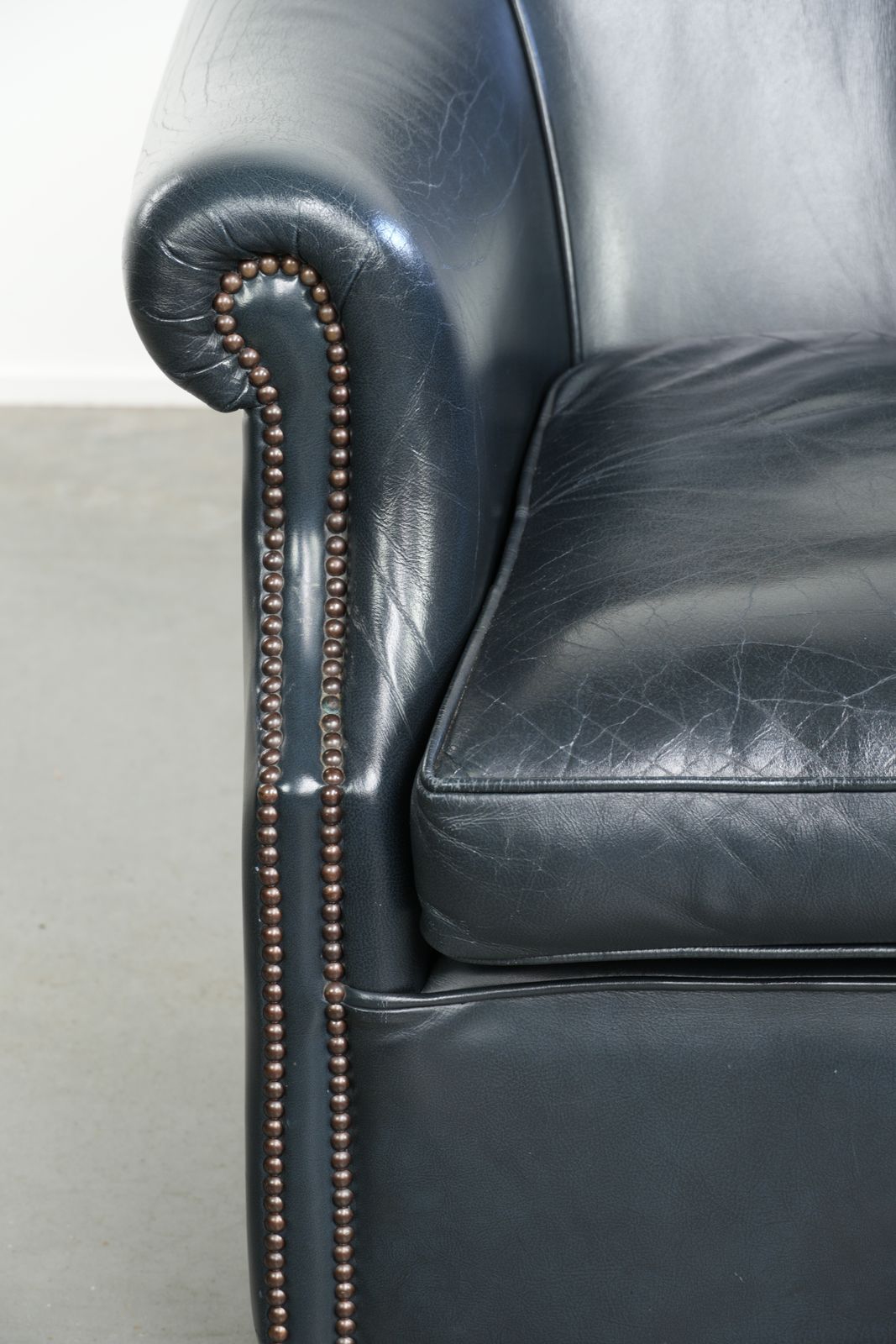 photo furniture Dark Blue Club Armchair Made Of Cowhide Leather With A Timeless Design