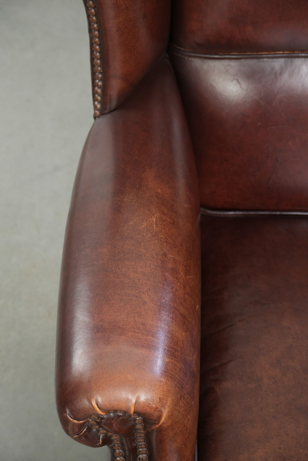 Elegant Vintage Sheepskin Wing Armchair With A Timeless English Look, Finished With Decorative Nails. photo buy