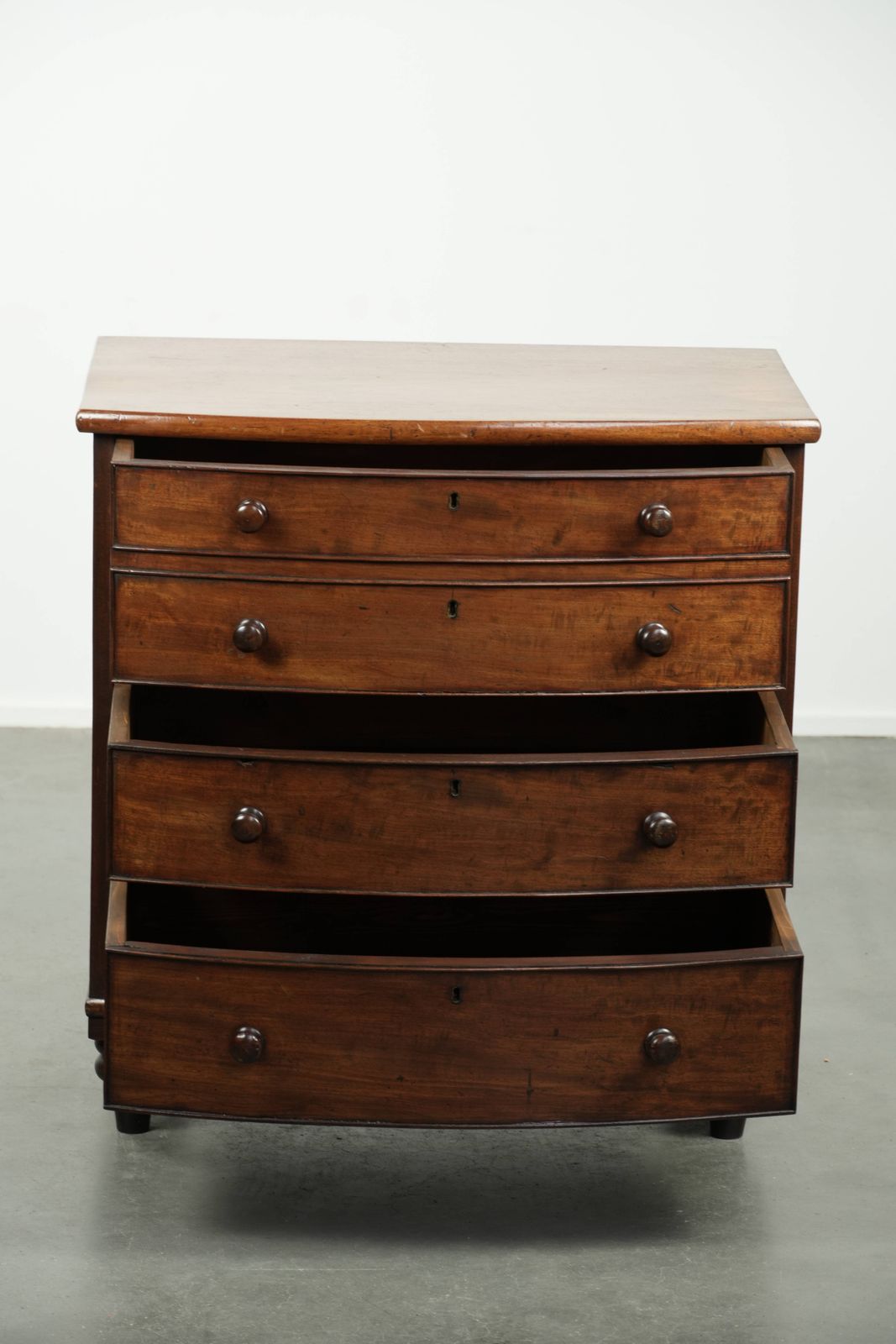 Antique 19th Century English Bow Front Chest Of Drawers In A Unique, Subtle Size With Beautiful Warm Colors. photo for sale