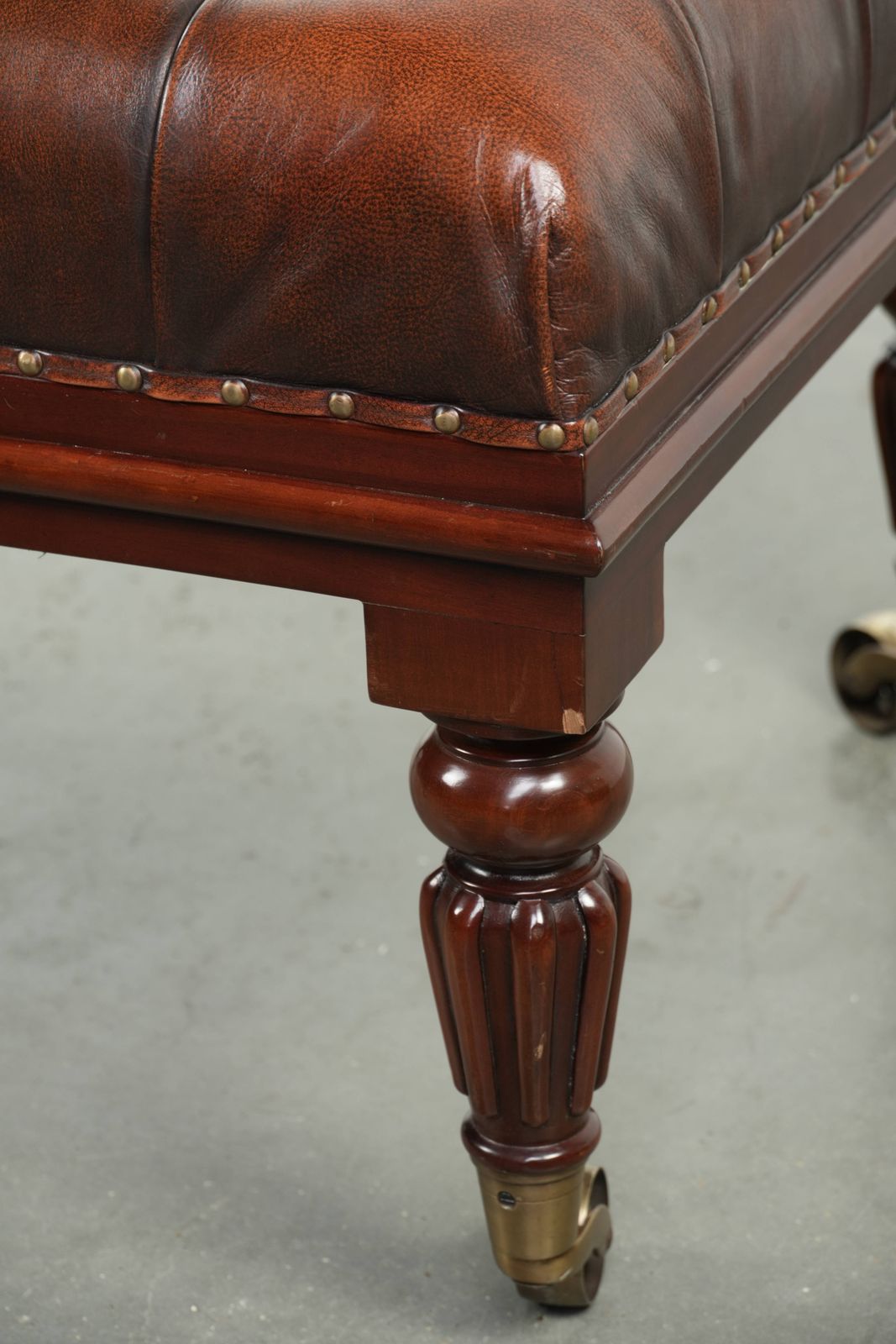 photo for sale Large Brown Cowhide Chesterfield Ottoman In English Style With Elegant Legs And Brass Casters