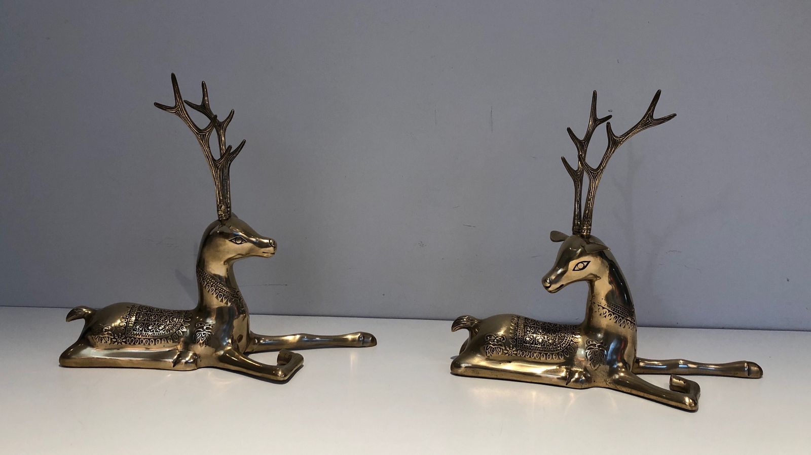 Pair Of Bronze Reclining Deer Engraved With Shamanic Motifs. French Work. Circa 1970 photo for sale