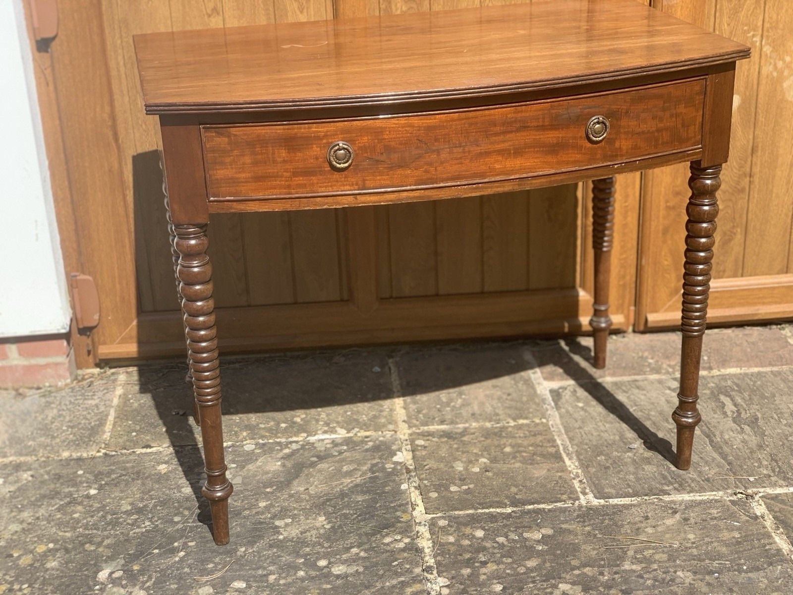 A Regency Bowfront Side Table With Bobbin Legs. photo buy