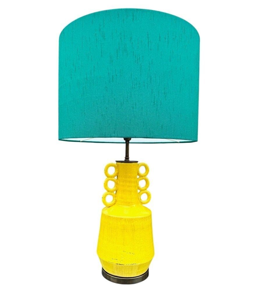 A Mid Century Style Yellow Ceramic And Bronze Lamp With Six Handle Design. photo vinterior