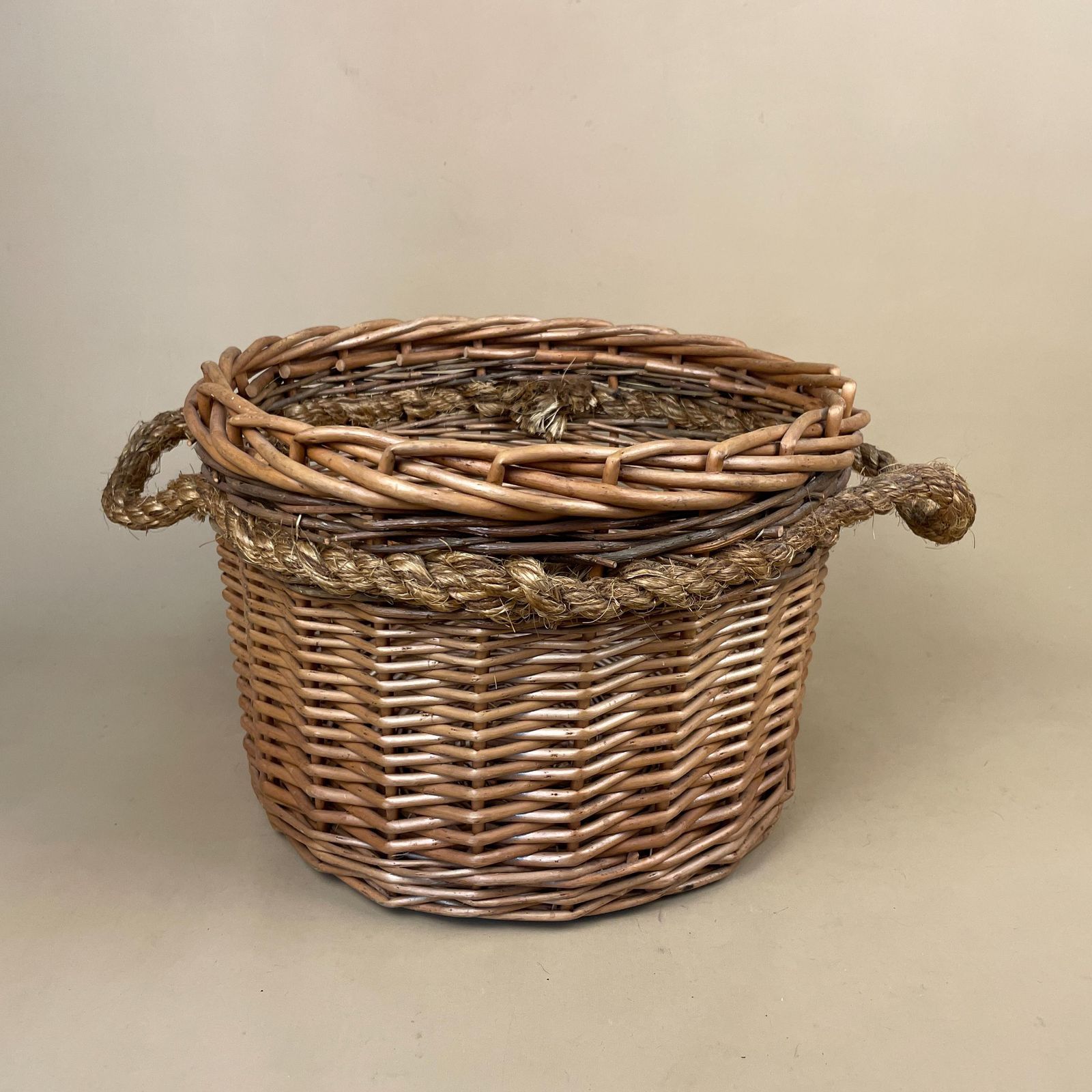 Vintage Round Basket Woven Wicker Brown Antique Cylinder Storage Farmhouse Cottage Decor Laundry Cane Wood Logs Fireplace Rope Handles photo furniture