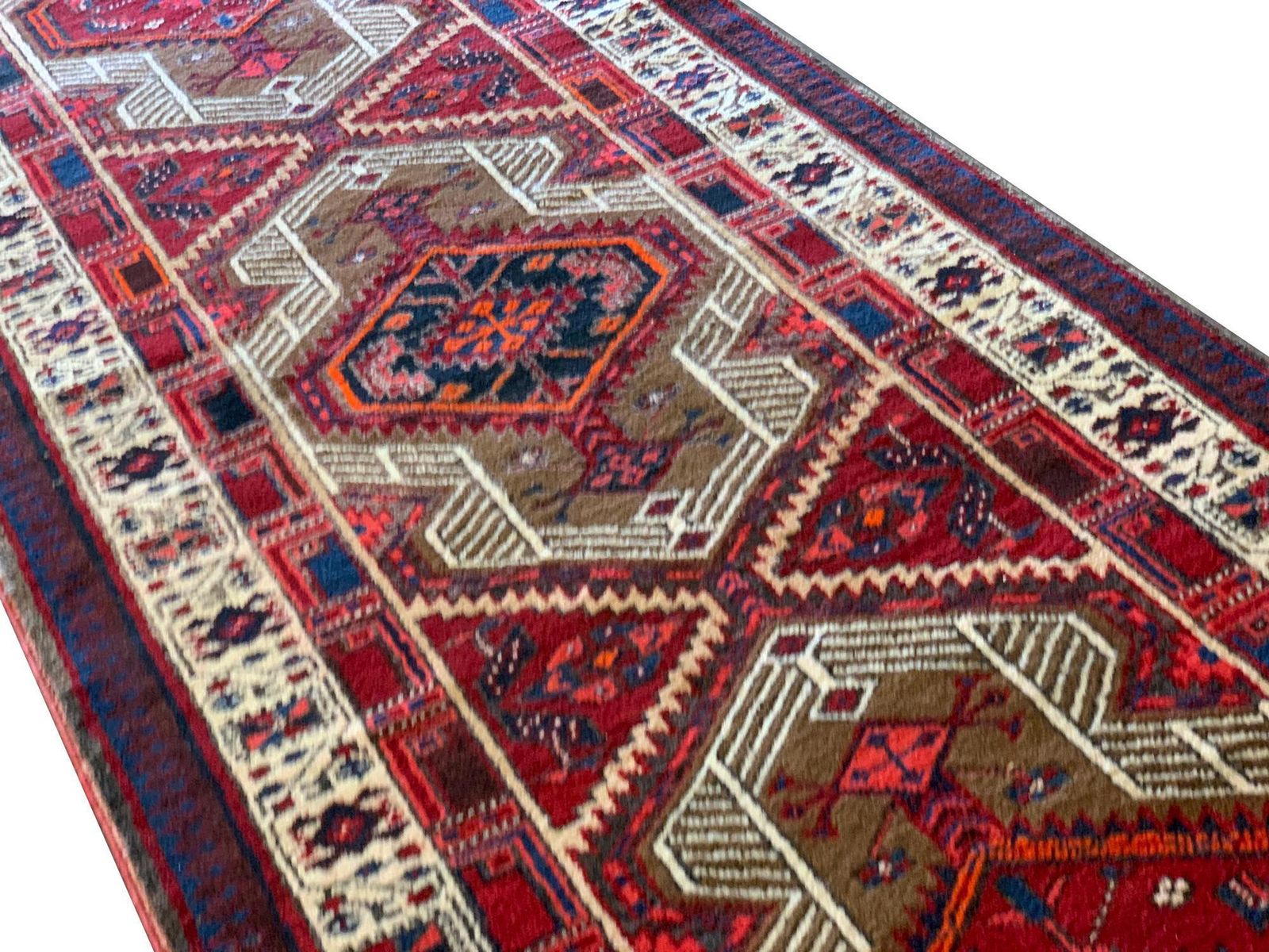 Handgemaakt loperkleed, geometrisch oosters motief, rood wollen tapijt photo Textiel
