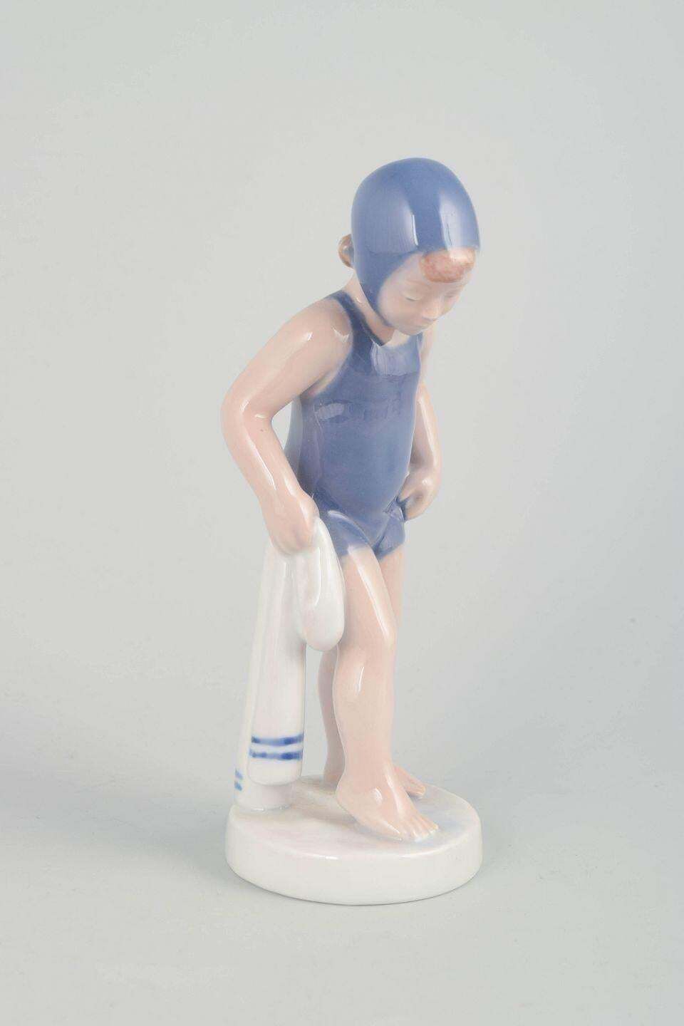 Royal Copenhagen. "The Swimmer" Porseleinen Beeldje Van Meisje In Blauwe Badpak. photo furniture