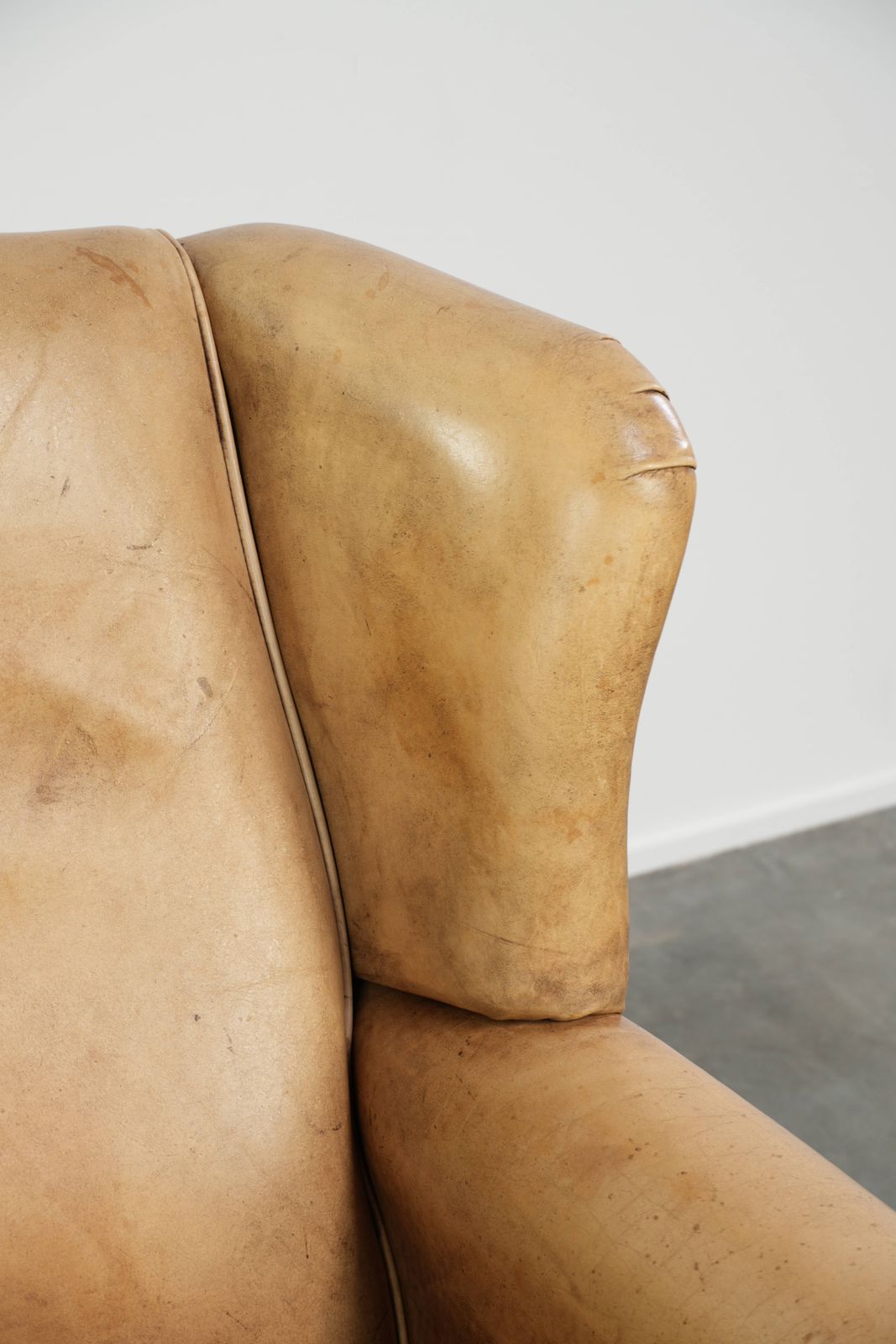 photo furniture Lichte koeienhuid fauteuil met vleugelleuningen, een mooie tijdloze Engelse uitstraling en goed zitcomfort.