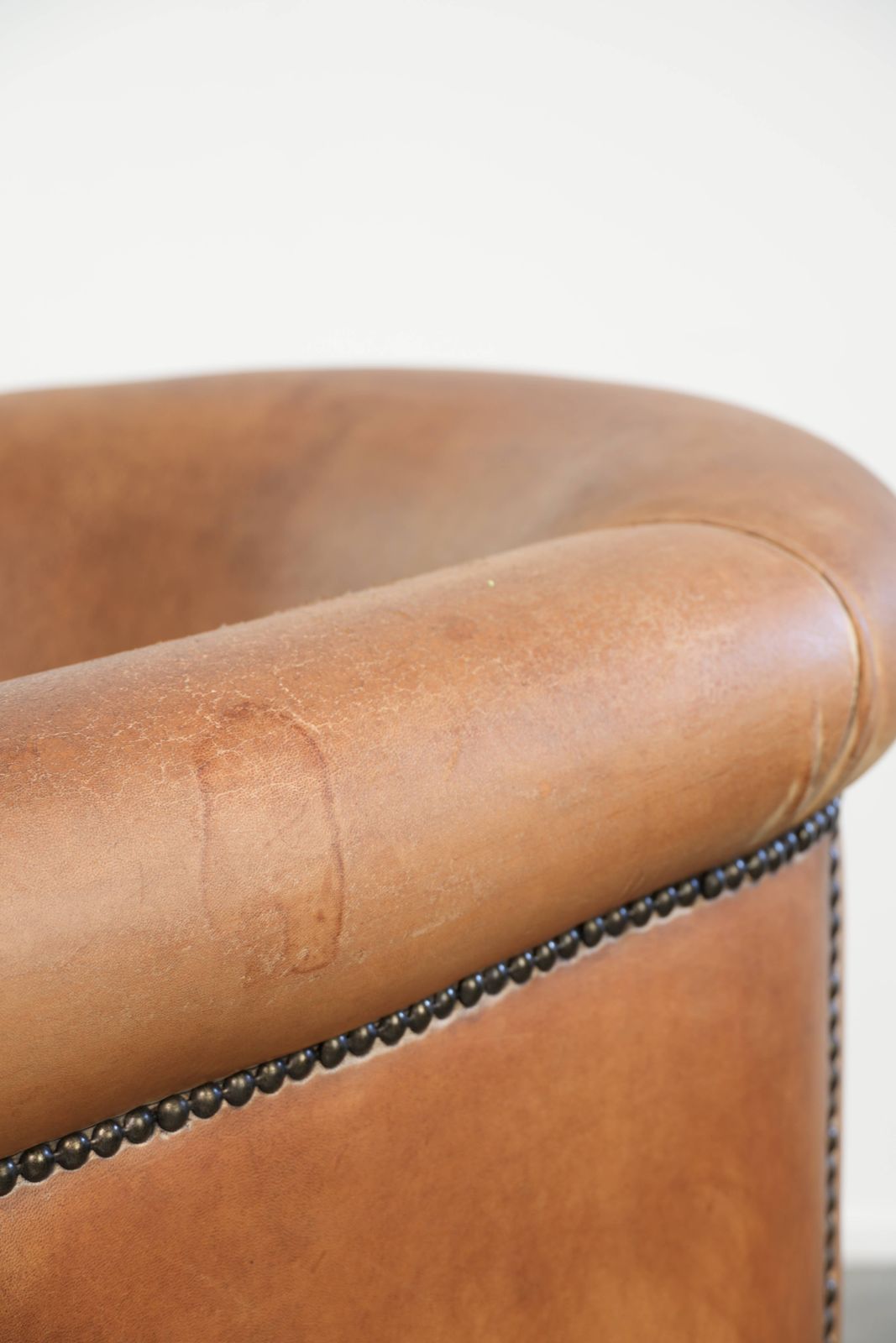 photo furniture Vintage schapenleren club fauteuil in lichtcognac met patina en tijdloos design