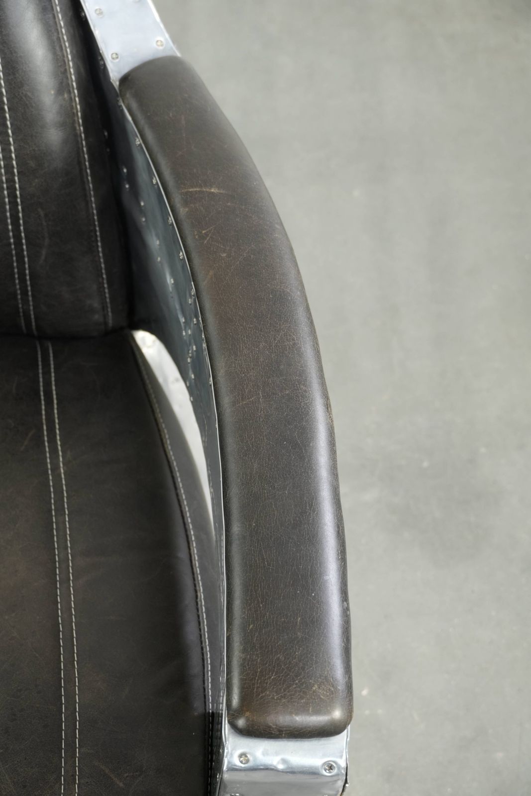 Unieke en comfortabele fauteuil in Aviator-stijl van koeienhuidleer met aluminium afwerking en klinknagels photo vintage