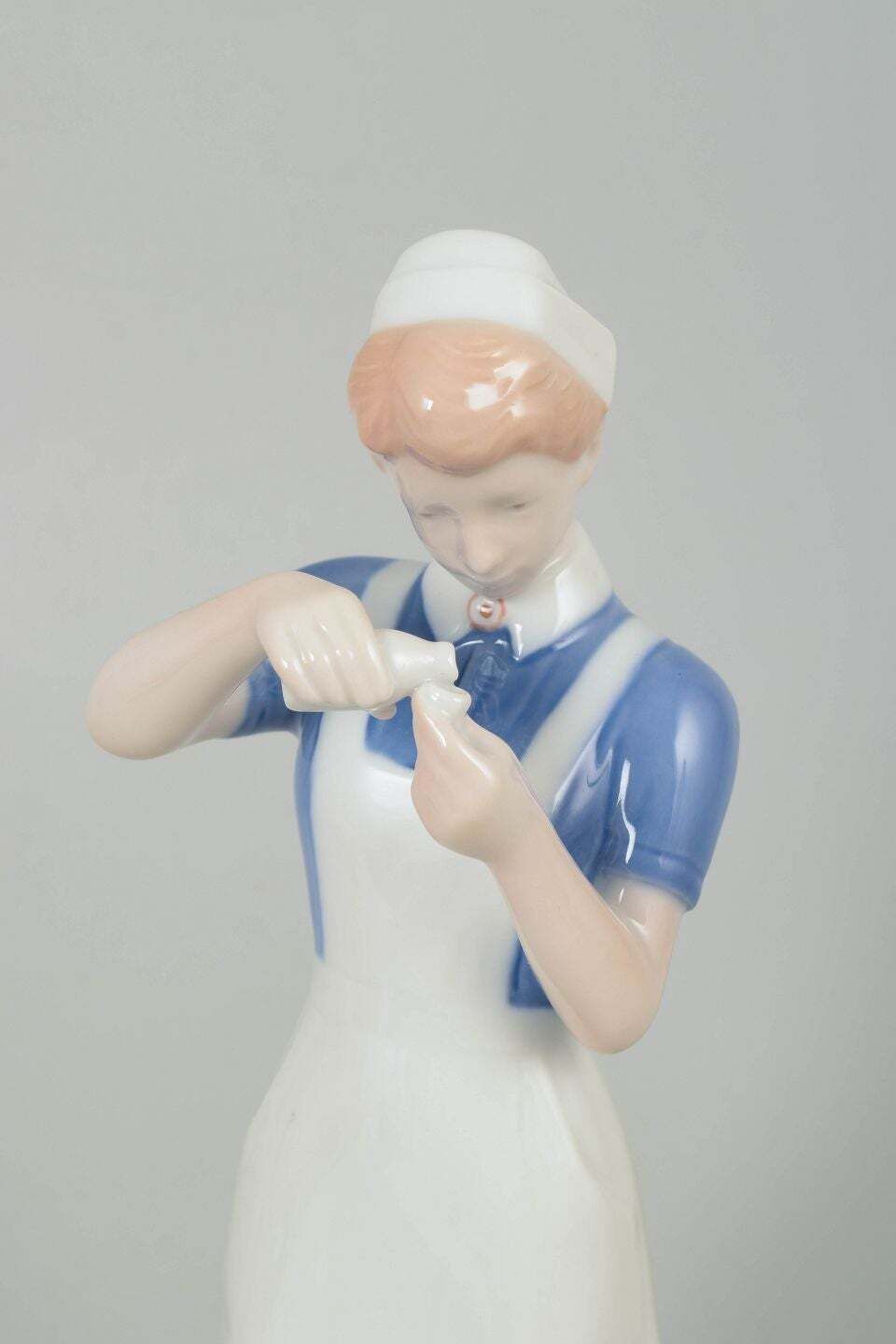 Bing & Grøndahl. Porcelain Figurine Of Nurse In Uniform. 1970s photo furniture
