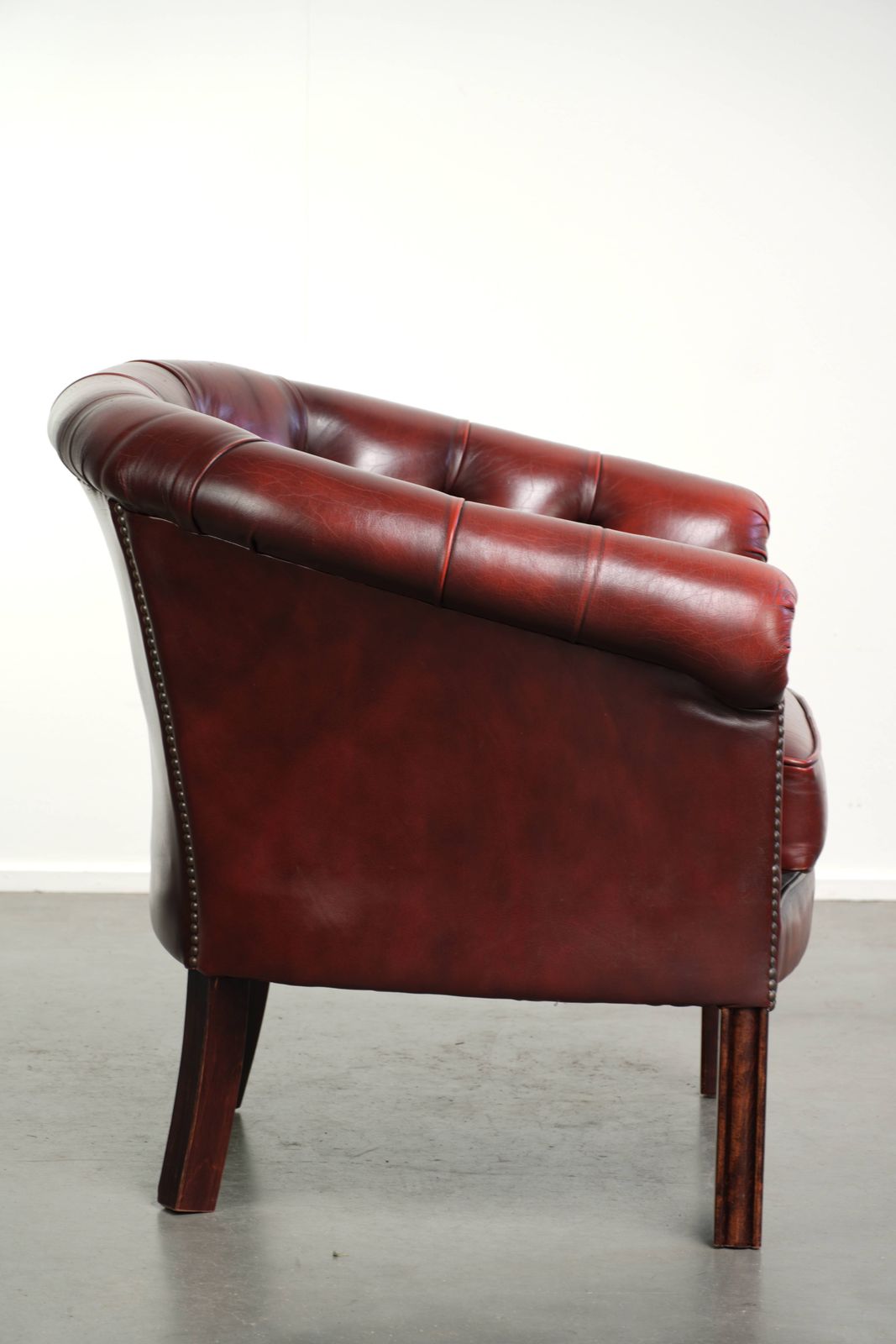Nice, Subtle Cowhide Chesterfield Club Armchair In A Sought After And Timeless Red Color. photo for sale