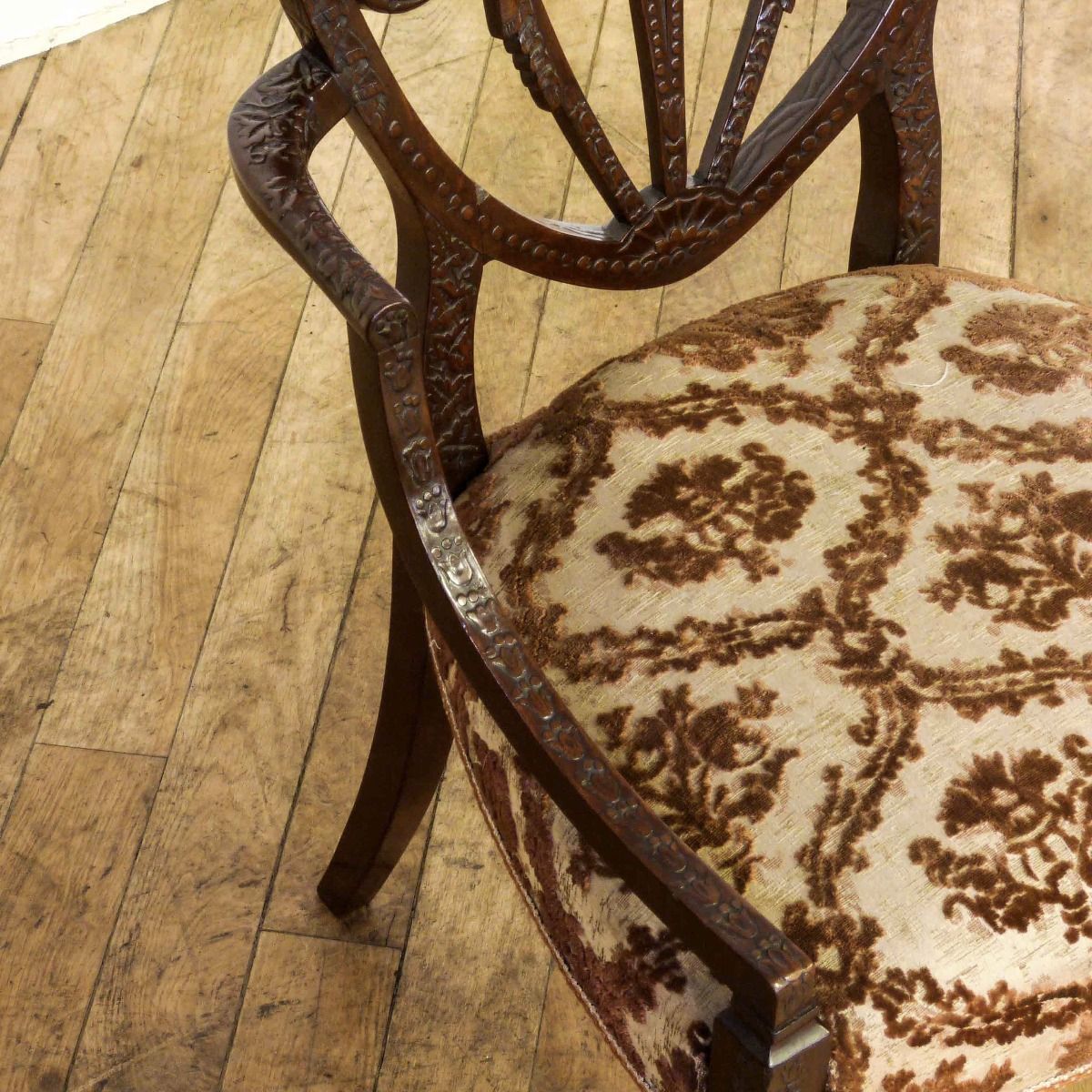 A Pair Of Edwardian Mahogany Armchairs In The Manner Of Hepplewhite. Profusely Carved With Foliage, Flowers, Ribbons And Swags. The Central Shield Bac photo for sale