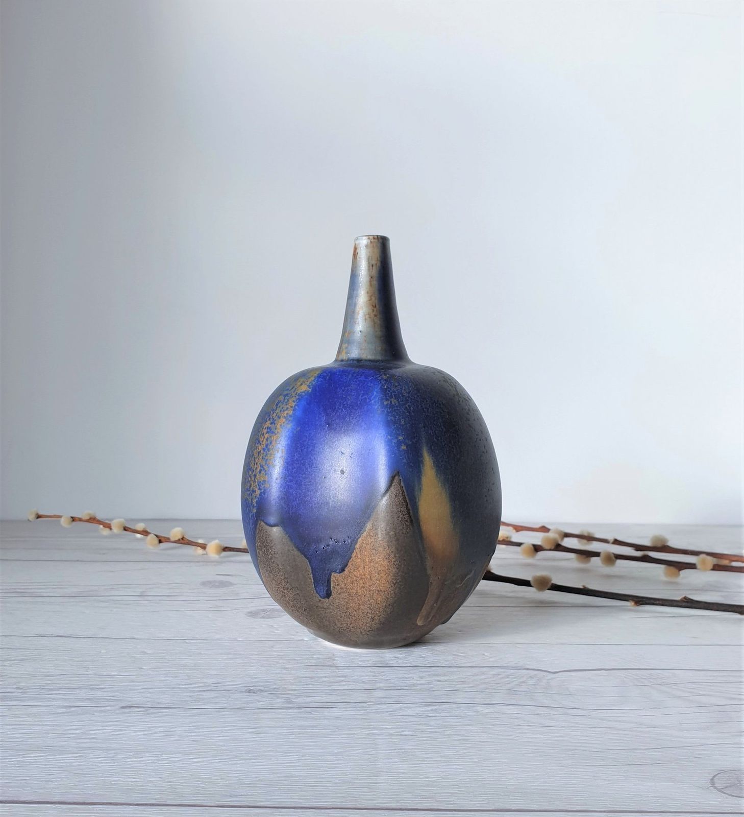 photo for sale Reiner Gehrig, Grünstadt Studio, Matte Cedar, Sand And Blue Running Glaze Bottle Vase | 1970s