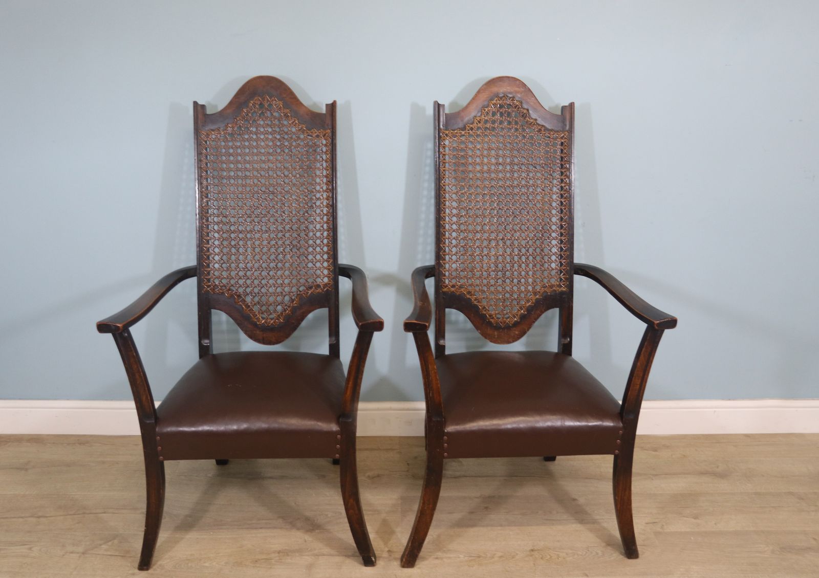 A Lovely Pair Of Early 20th Century Industrial Looking Cane Shield Back Armchairs