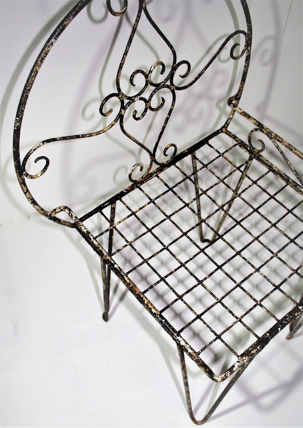 photo furniture Beautiful Weathered Wirework Scroll Iron Garden Chair