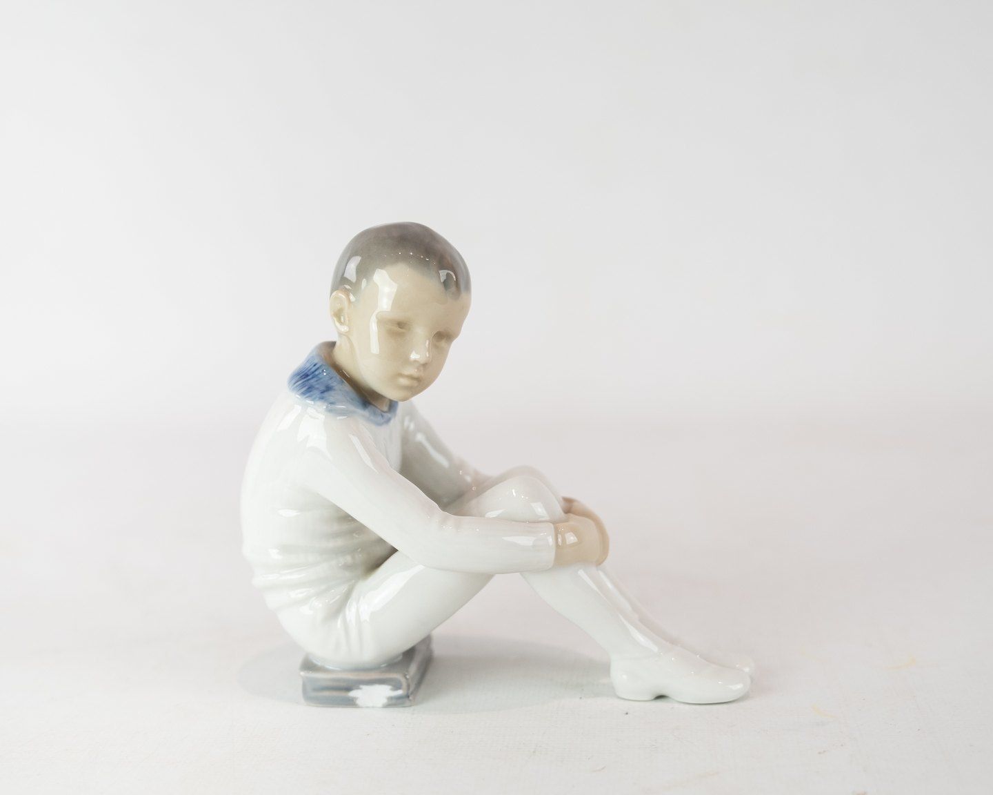 Porcelain Figure, Seated Boy, No .: 1742 By Bing And Grondahl. photo furniture