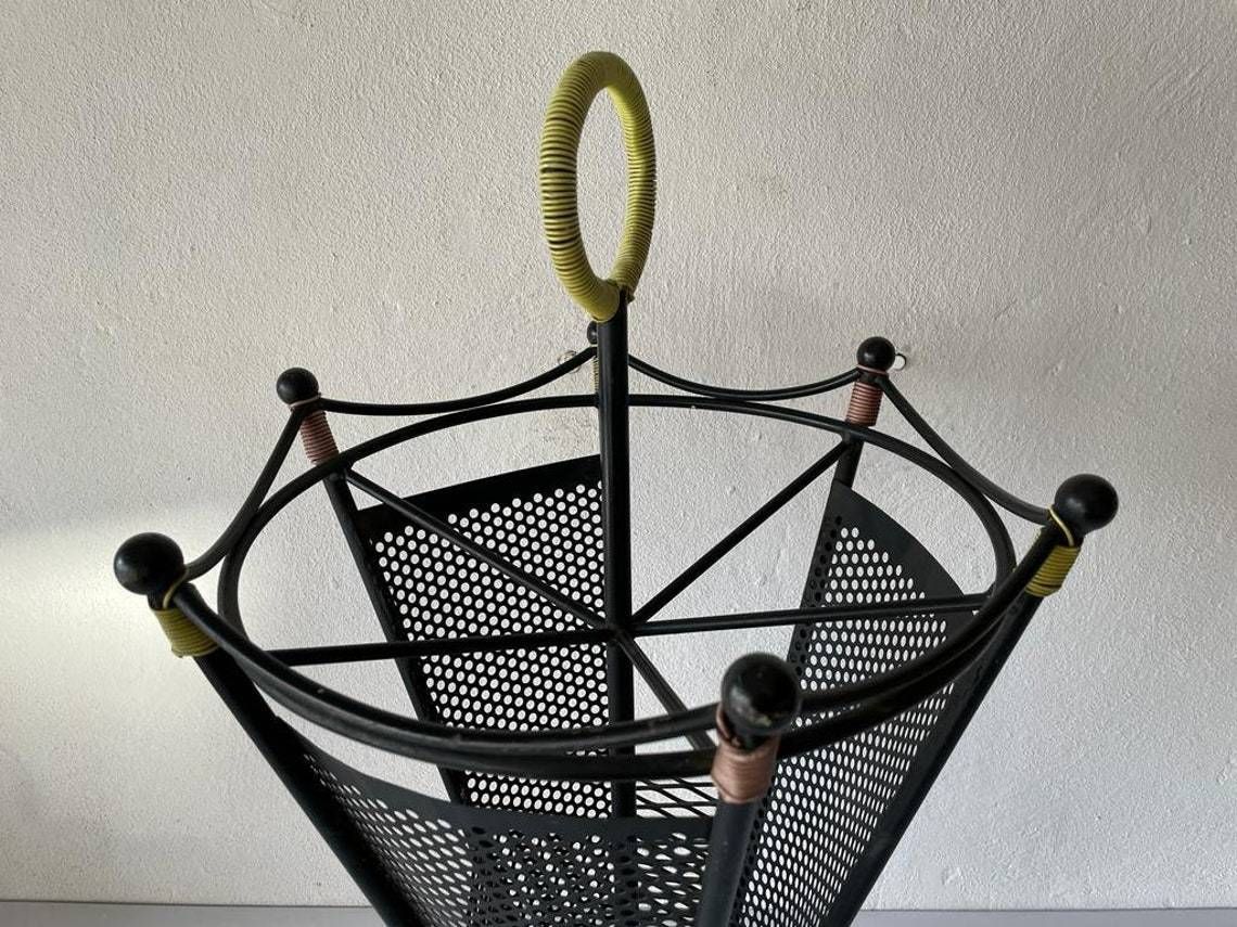photo for sale Black Metal 6 Slot Umbrella Stand With Yellow Circle Handle, 1950s
