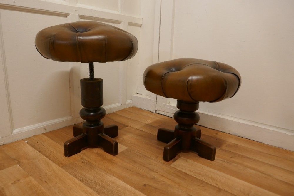 A Pair Of Sturdy French Button Leather Swivel Piano Stools