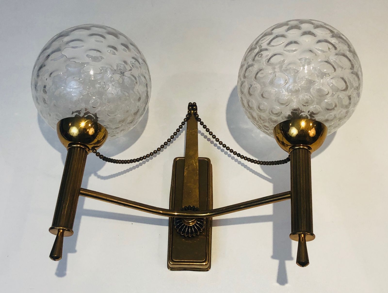 photo for sale Pair Of Brass And Glass Ball Sconces. Around 1970
