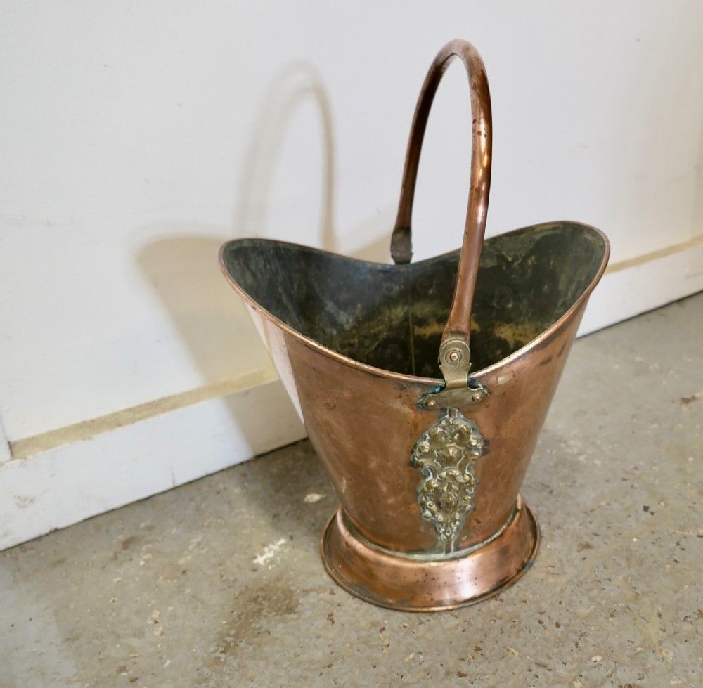 An Art Nouveau Embossed Copper Helmet Coal Scuttle photo furniture