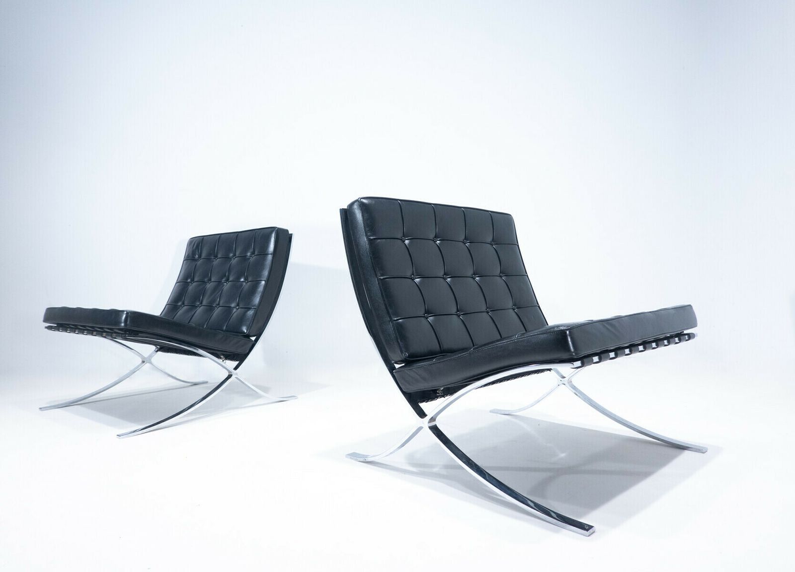 Pair Of Black Leather "Barcelona" Chairs By Mies Van Der Rohe For Knoll
