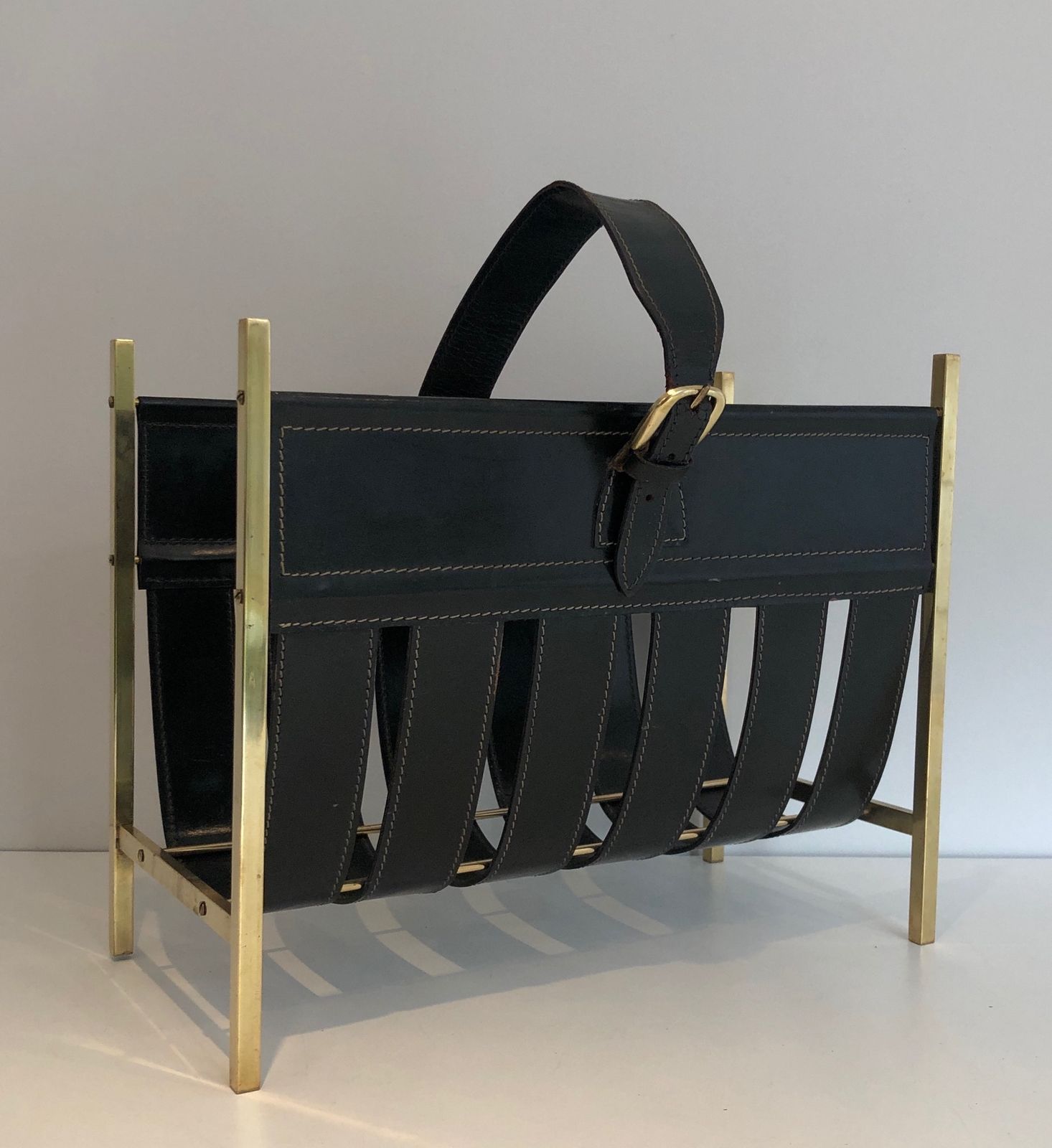 Brass And Leather Magazine Rack Representing A Handbag. Work Of Jacques Adnet. Around 1940