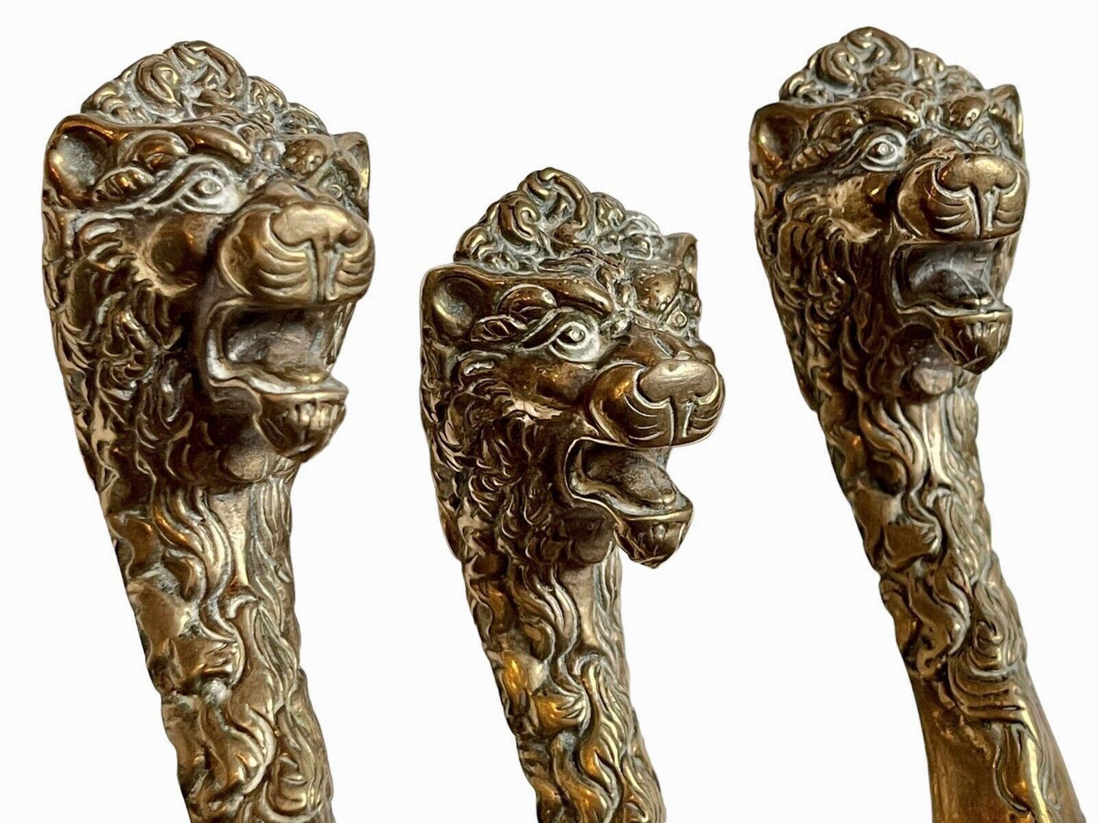 A Set Of Brass Lion Head Fire Irons