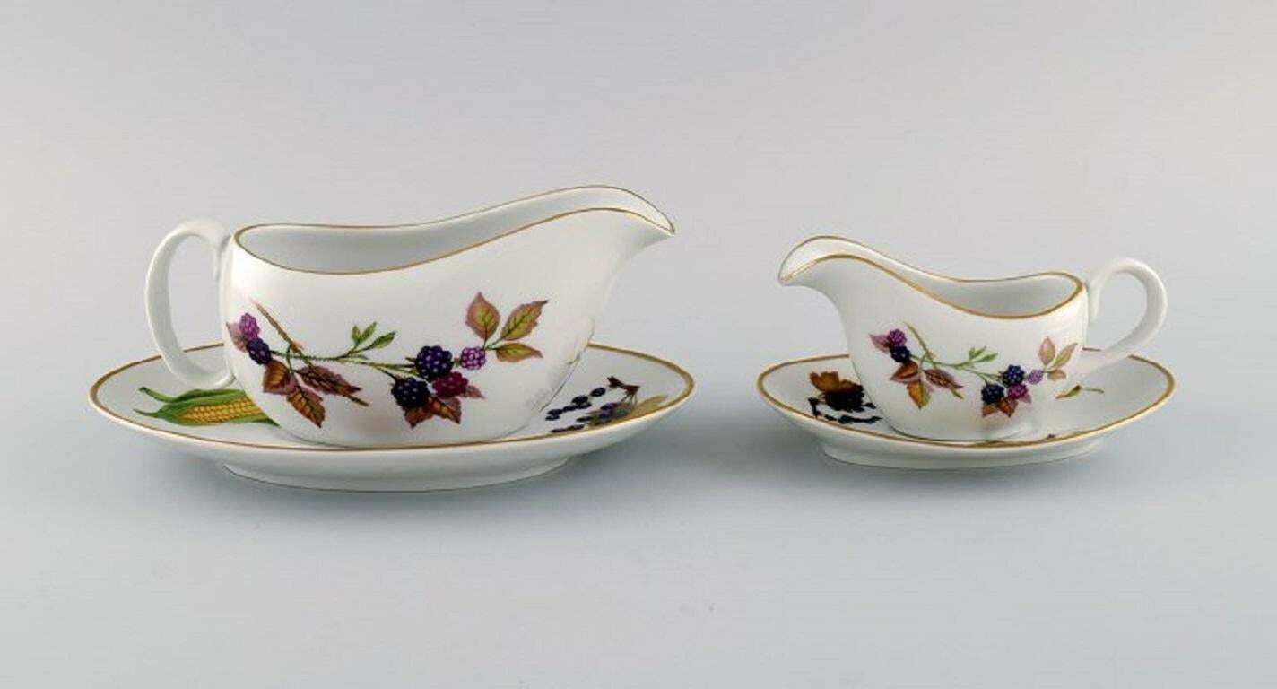 Royal Worcester, England. Two Evesham Sauce Jugs With Saucers In Porcelain.