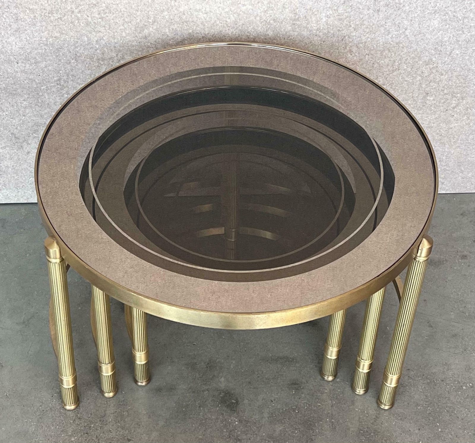 Furniture Set Of Three Round Brass Nesting Tables With Smoked Pink Glass Tops photo
