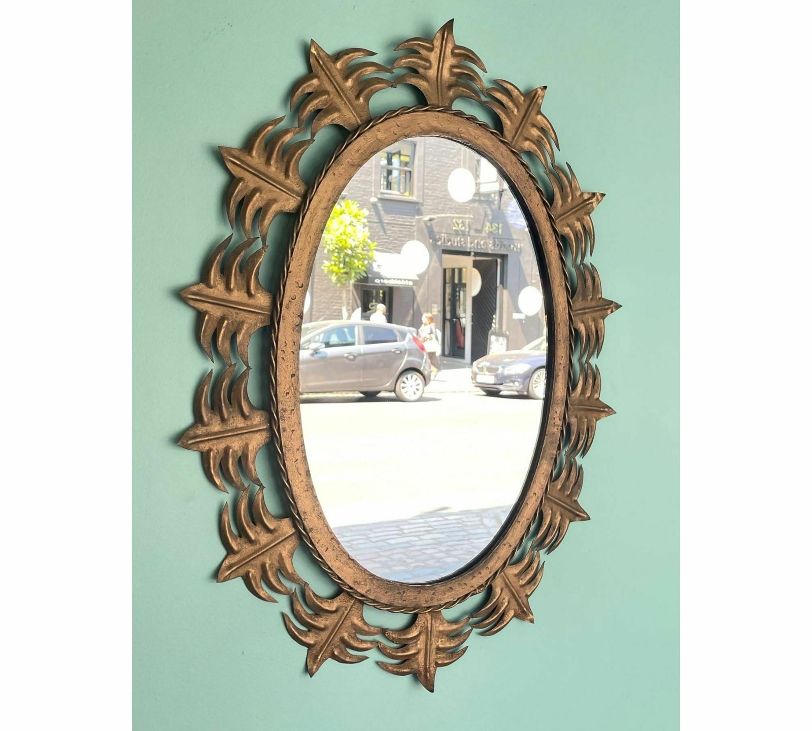 A Spanish Sunburst 1950s Gilt Metal Oval Mirror With Ornate Edging. photo furniture