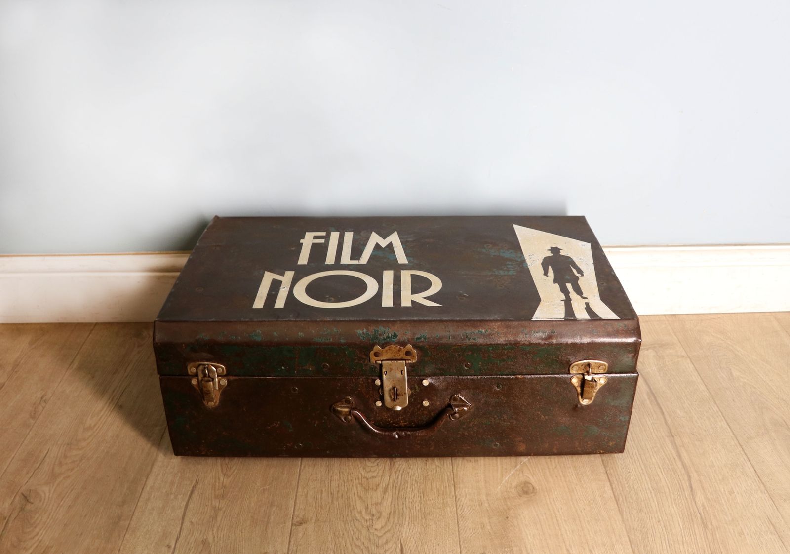 A Vintage Metal Trunk Later Sign Written For Film Noir.