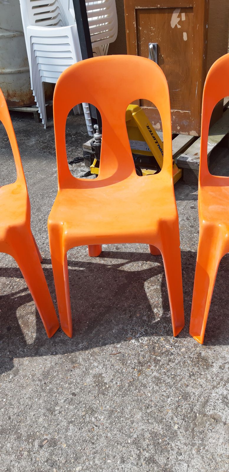 12 Stackable Orange Plastic Chairs photo 368.28