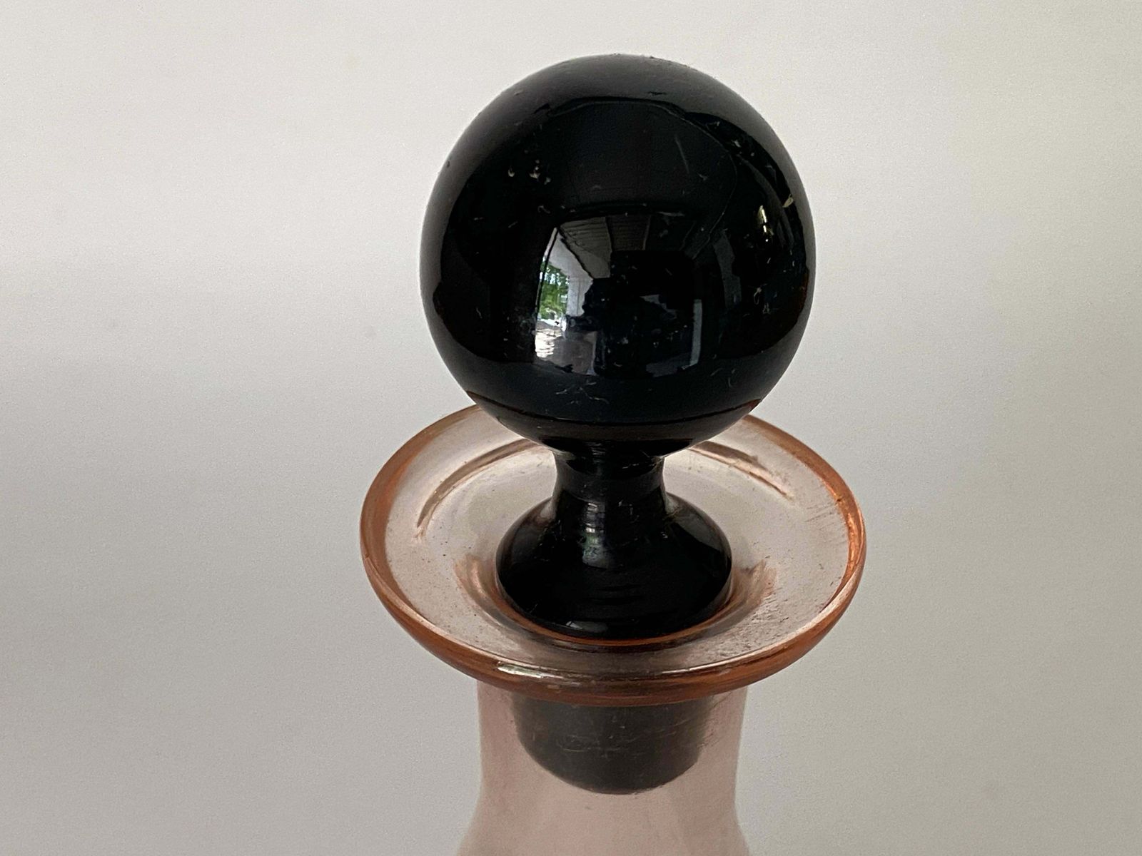 Decorative Vintage Pink Glass Bottle In Glass With Black Cap, France, Circa 1940 photo vinterior