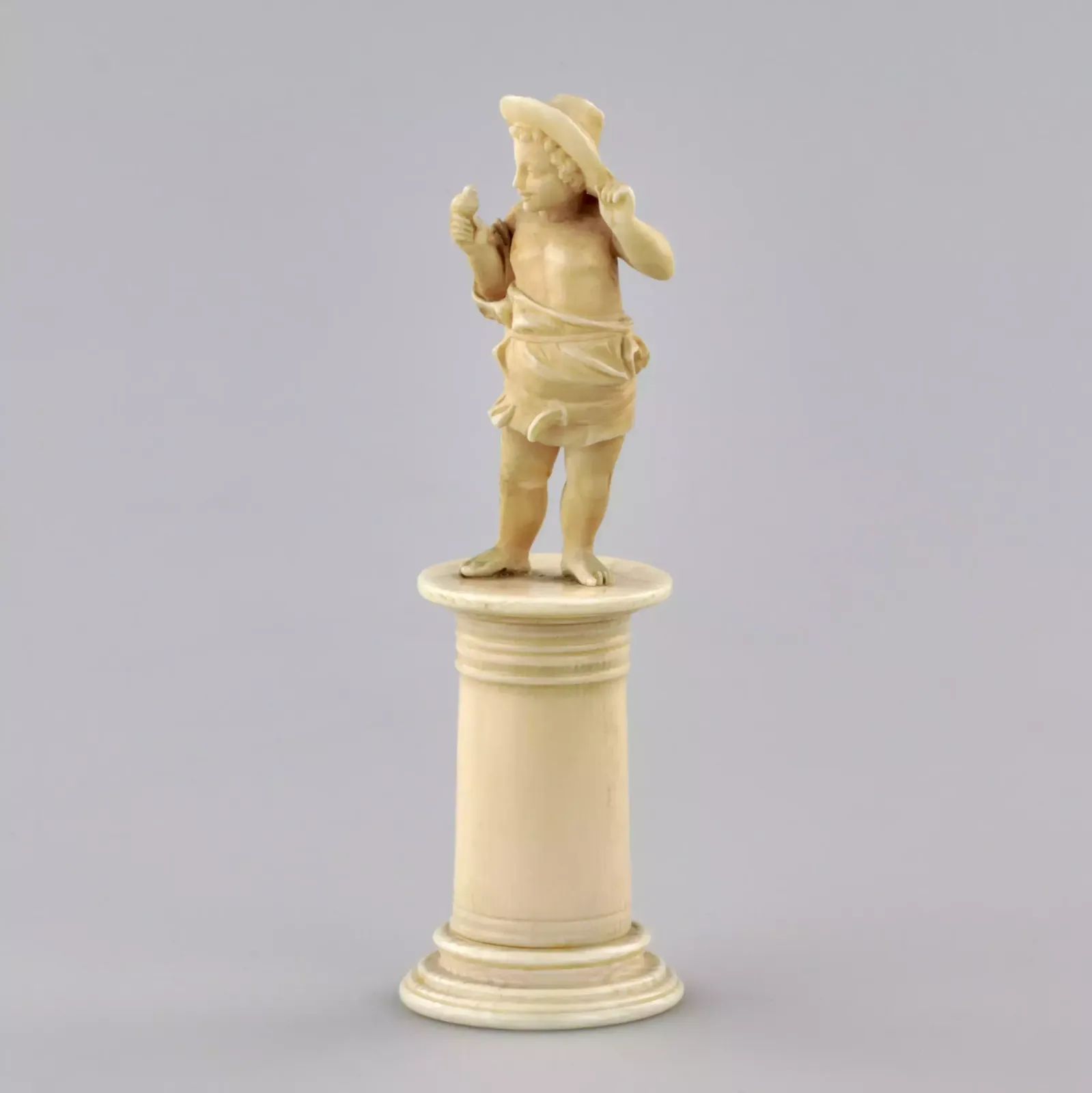 Carved Ivory Figurine Of A Boy With A Bird 1800s. photo furniture