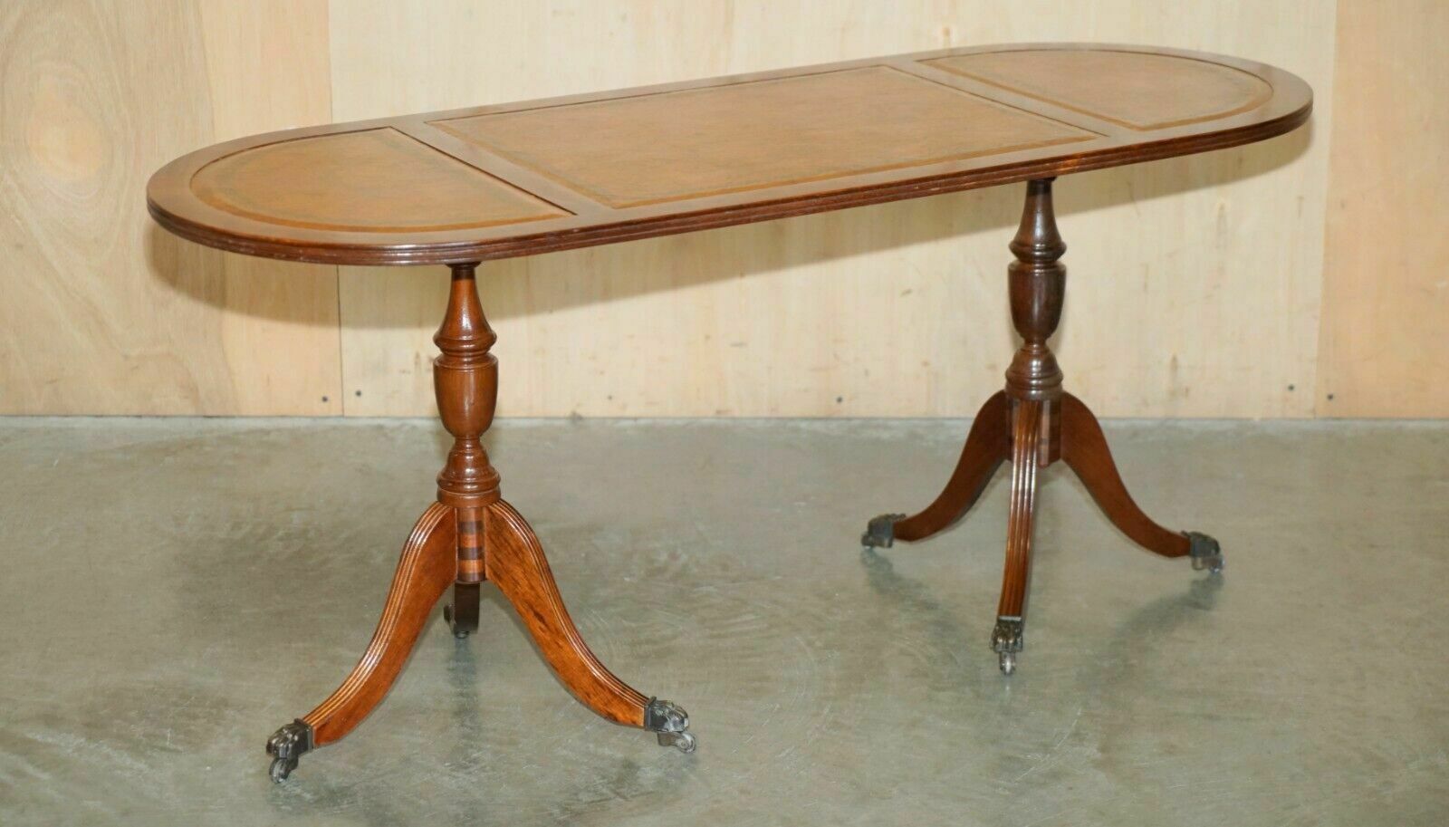Vintage Hand Dyed And Aged Brown Leather Oval Coffee Table With Lion Castors photo furniture