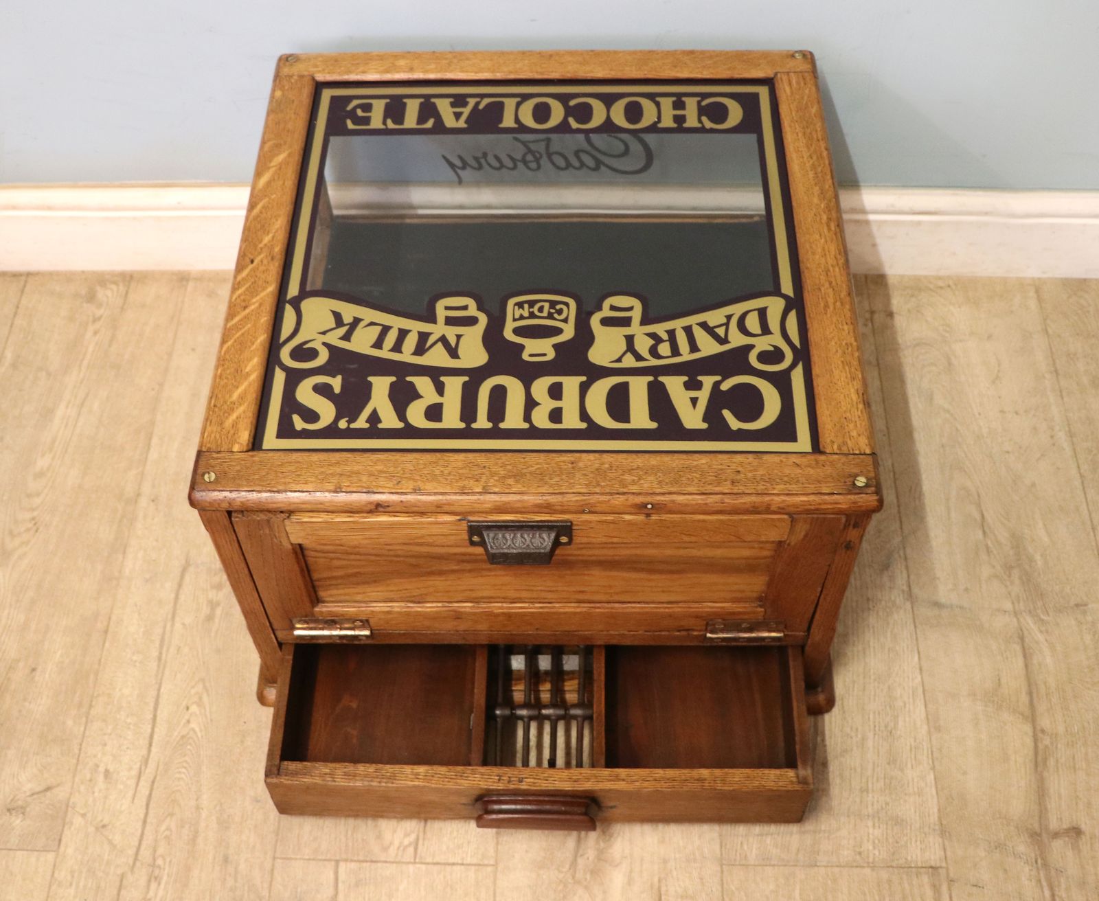 A Lovely Early 20th Century Oak Countertop Display Cabinet, Later Sign Written For Cadburys Chocolate. photo for sale