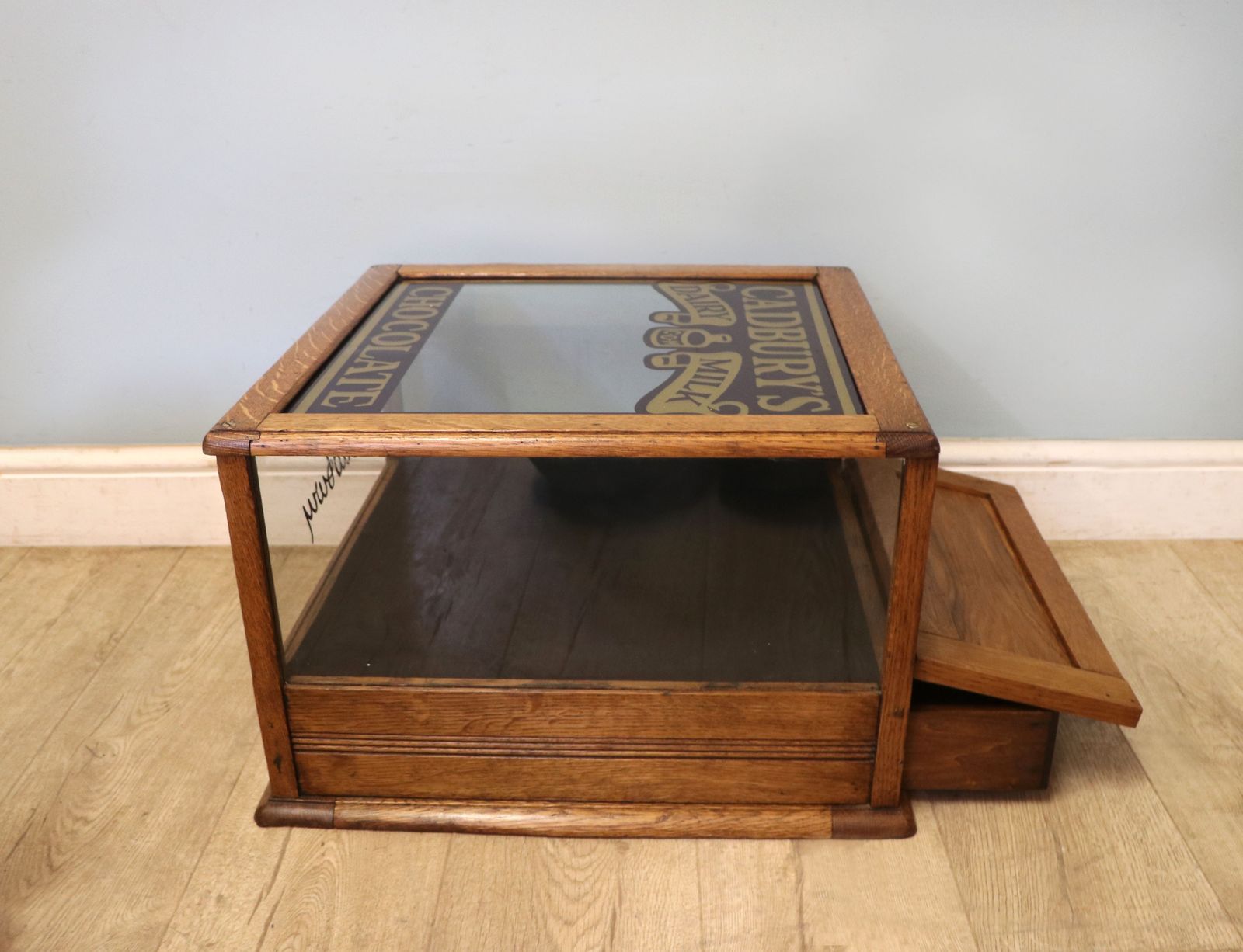 A Lovely Early 20th Century Oak Countertop Display Cabinet, Later Sign Written For Cadburys Chocolate. photo vinterior