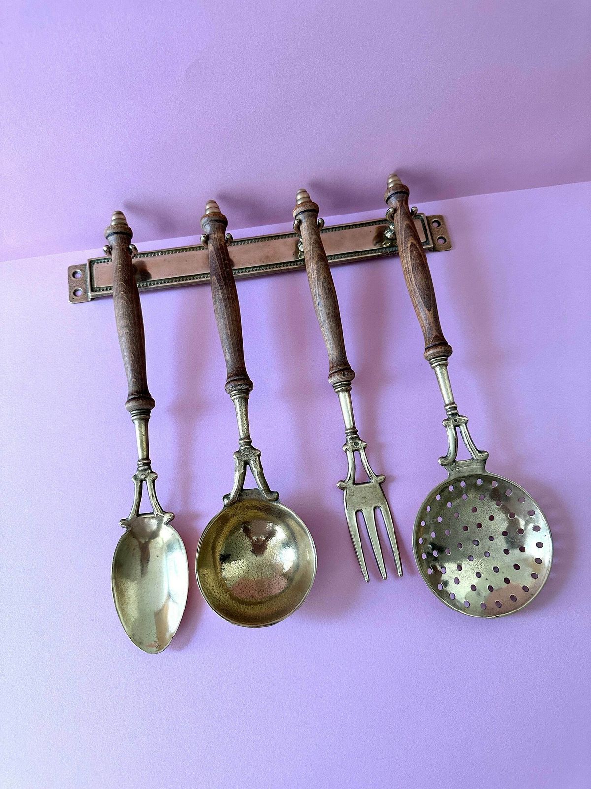 Vintage Brass Utensils Set. Wall Mounted Antique Cooking Utensils With Wooden Handles. photo vintage