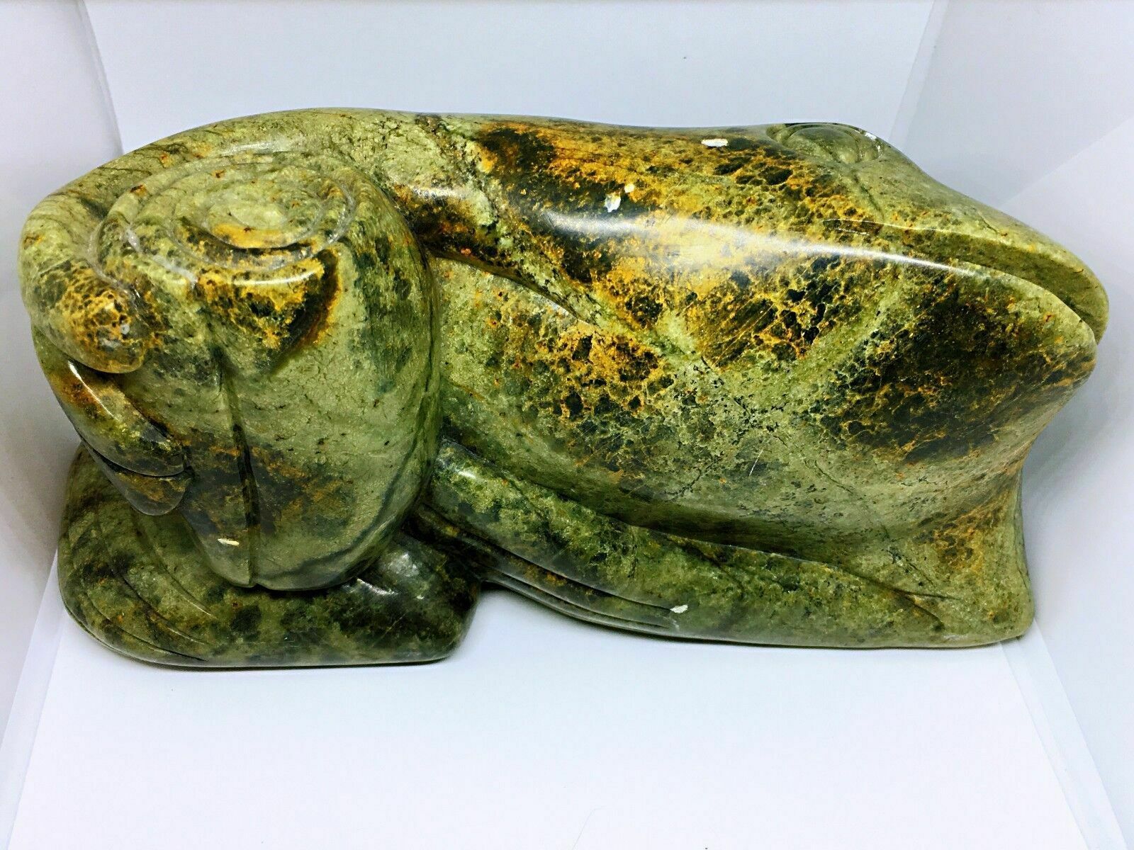 Jade(tough, Green Mineral Either Jadeite Or Nephrite Amphibole)frog With A Book photo buy