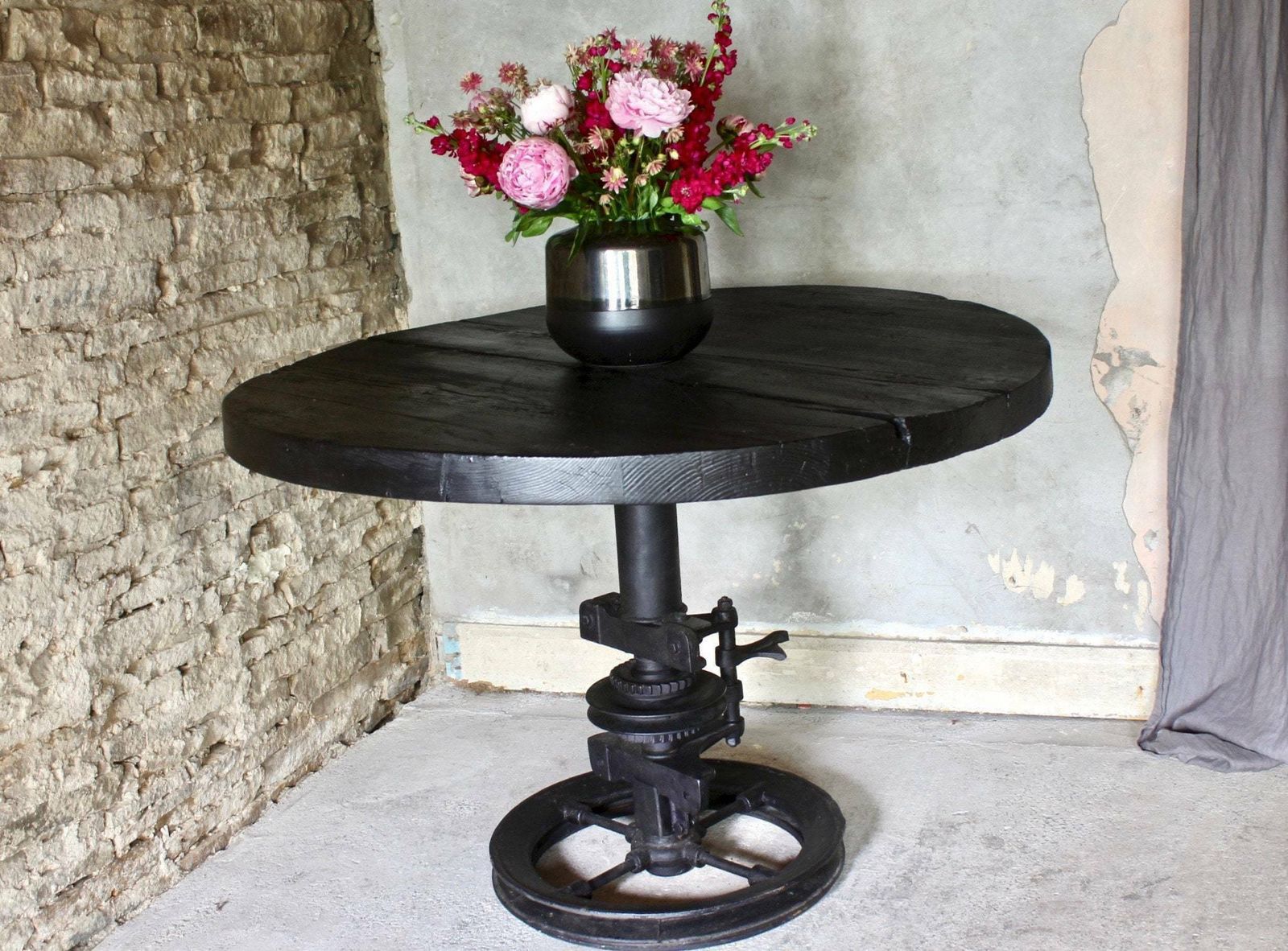 Shift Reclaimed Chunky Scorched Timber Circular Table With A Heavy Pedestal Base Made Out Of An Old Gear System photo vinterior
